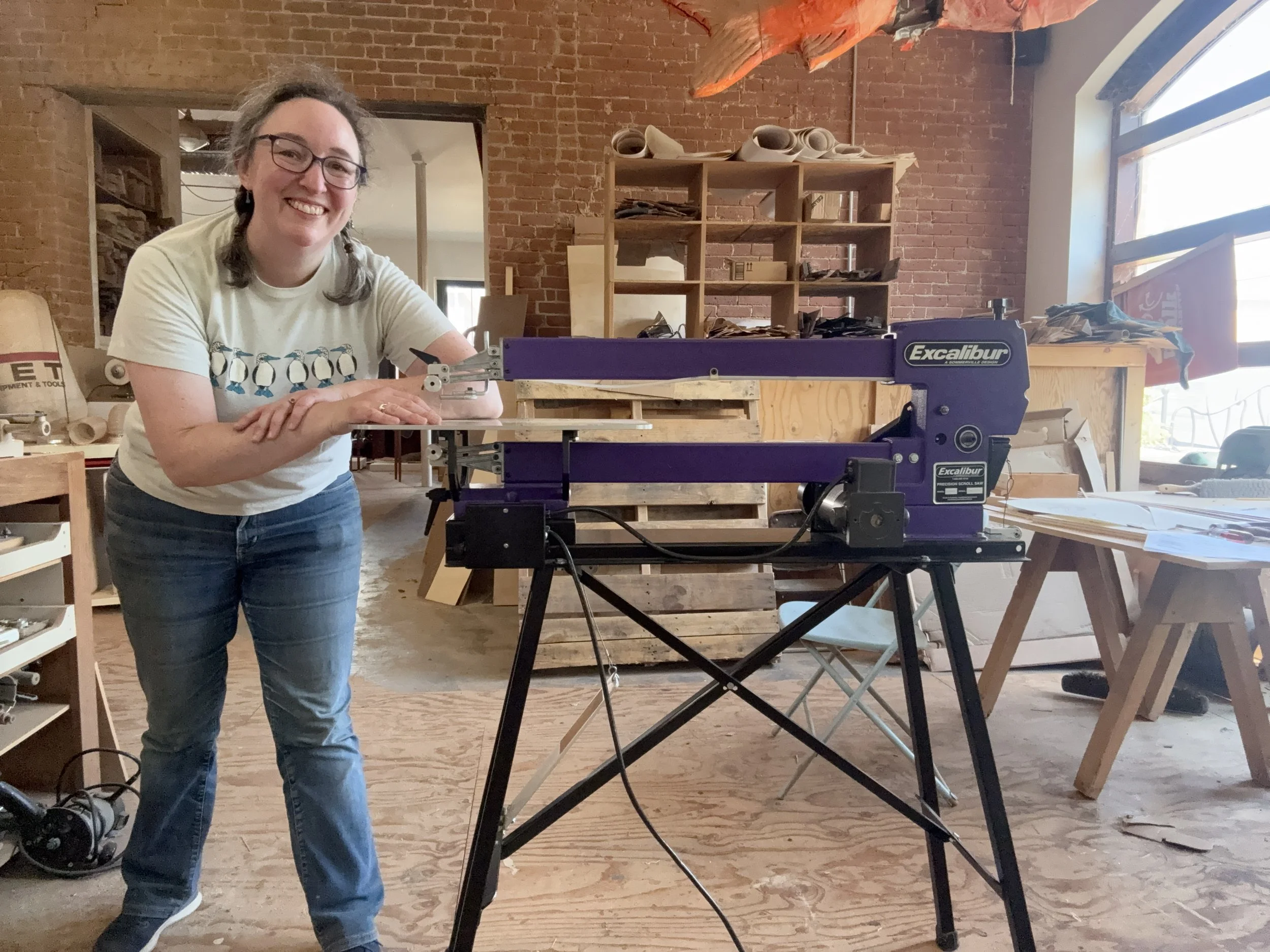 Photograph of me in the woodshop next to my new scroll saw