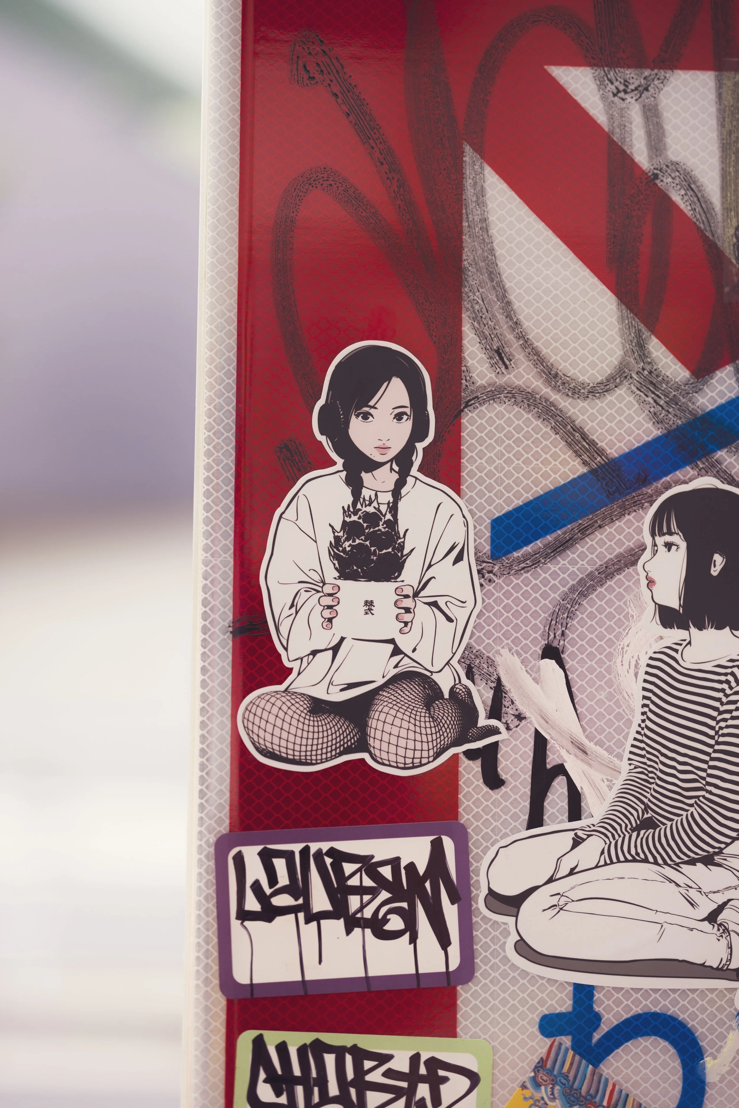 An illustrated sticker of a girl with black hair in braids, wearing a white oversized shirt and fishnet stockings, sitting cross-legged and holding a potted plant with spiky leaves.