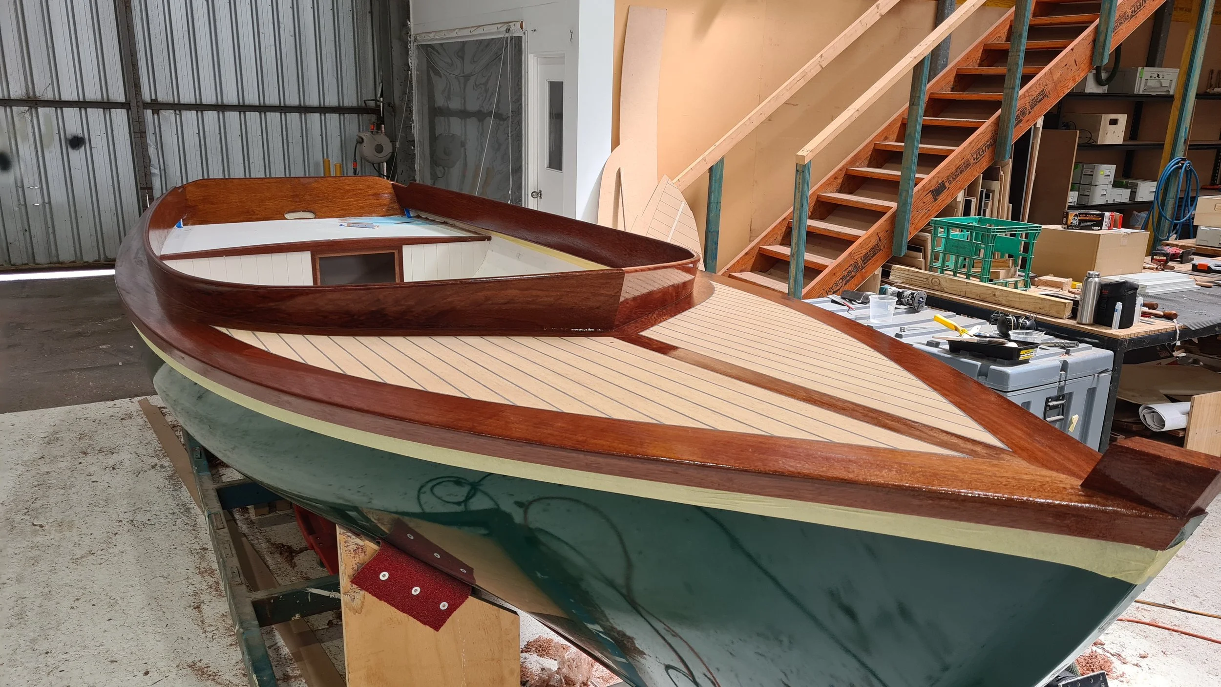 Haven sail boat with first coats of timber trim being varnished.