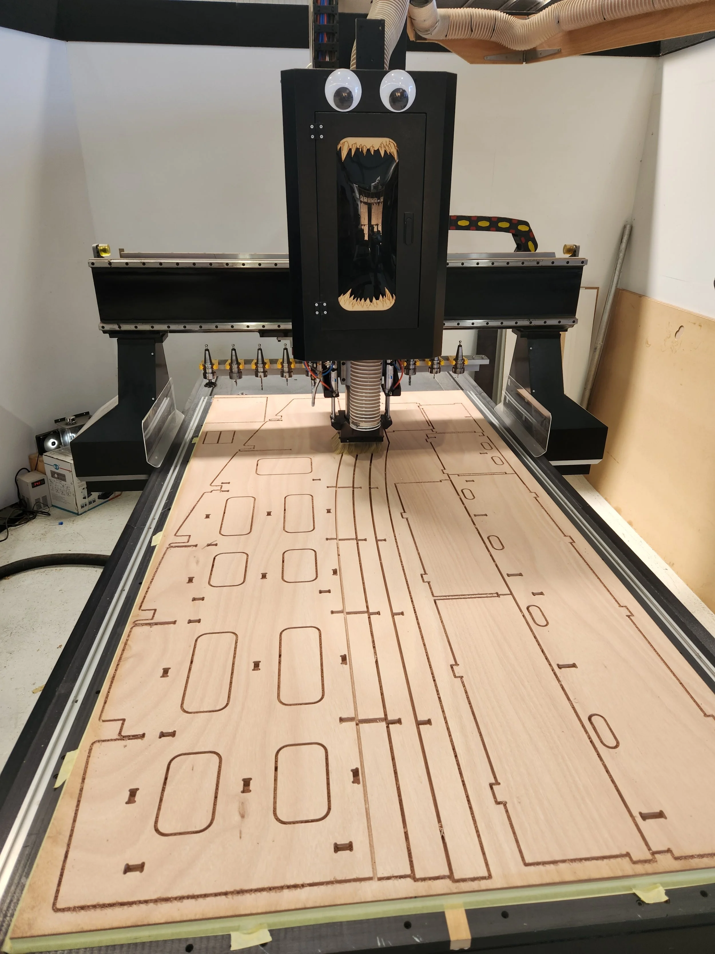 CNC Cutting marine plywood for internal battery assembly for inside a curved hull.