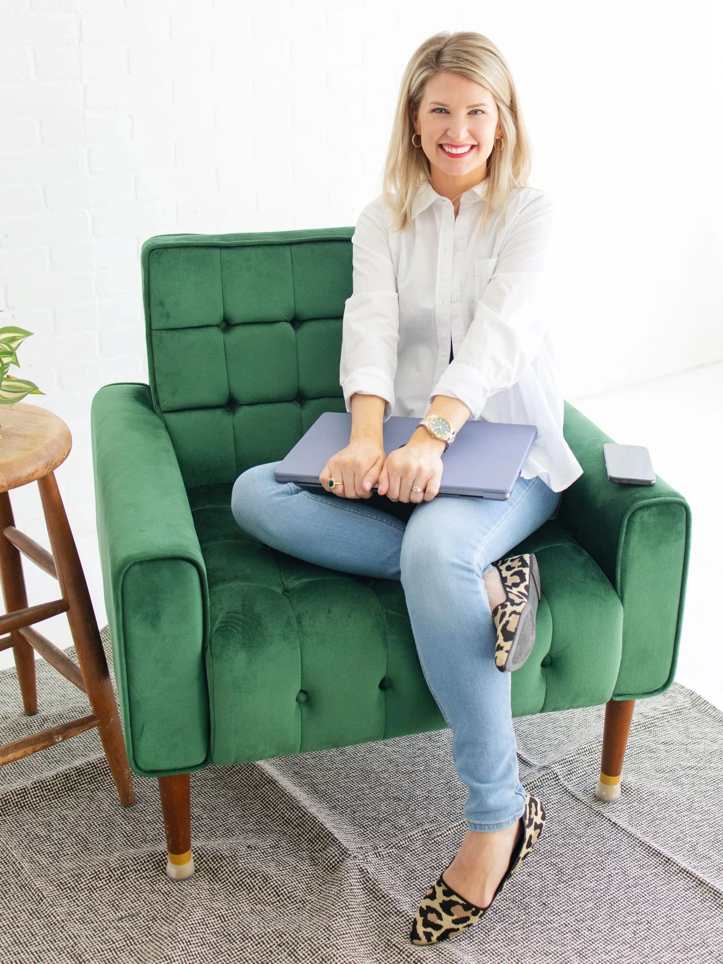 Mary Lou Hoover, Squarespace web designer and UX strategist at Cardinal Web Services, sitting in a green chair