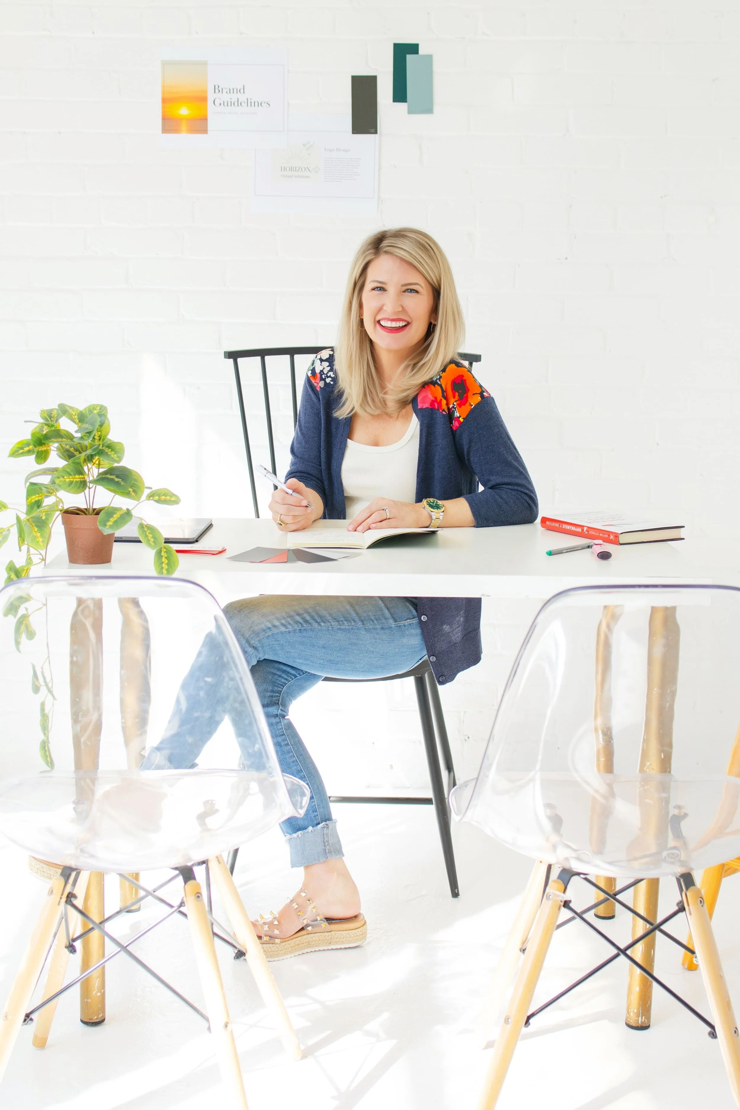 Mary Lou Hoover, web designer and UX strategist at Cardinal Web Services, sitting at a desk in a bright modern workspace