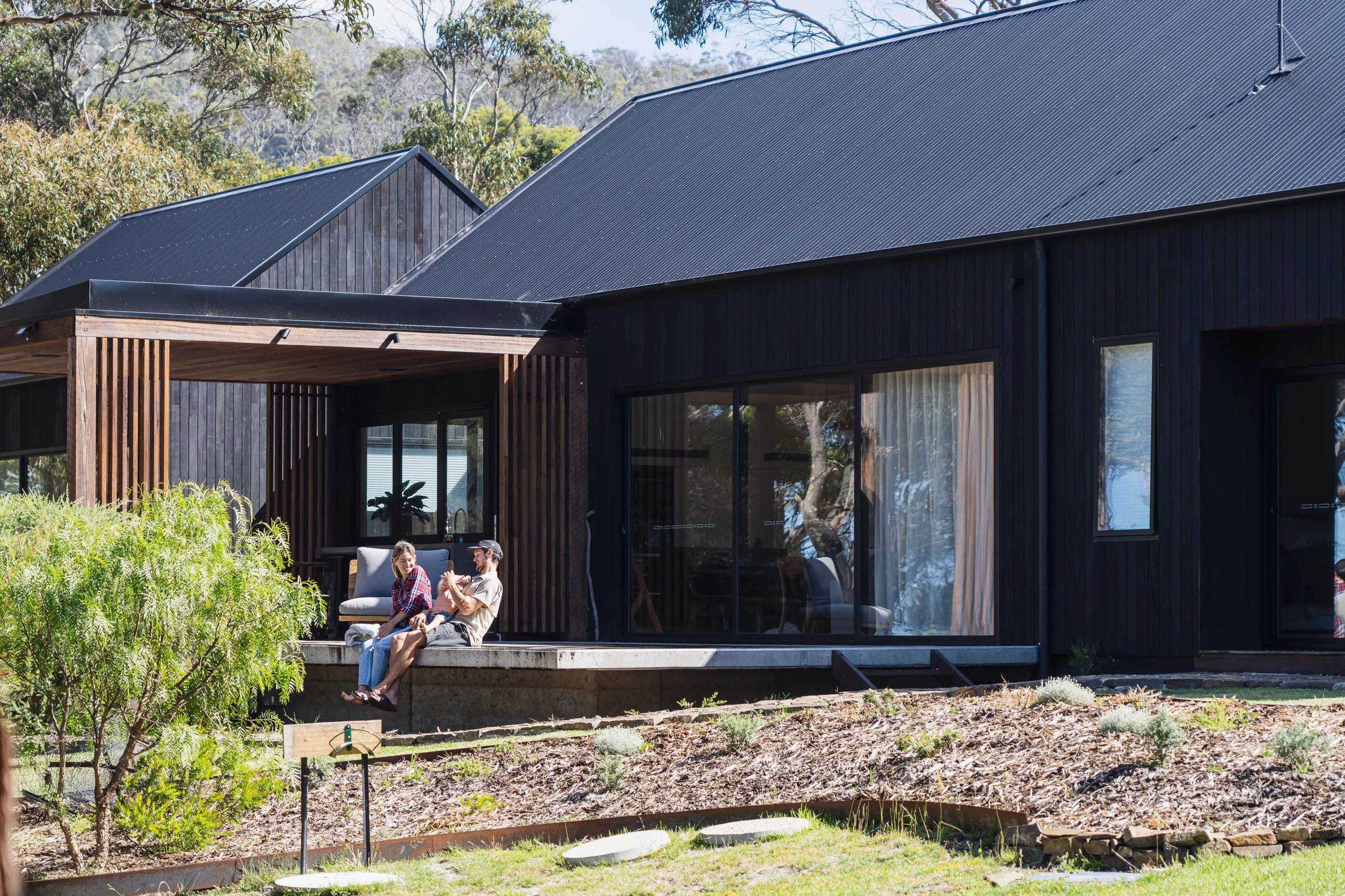 Rural dream home cantilevered deck with Shou Sugi Ban cladding and ironbark screening in Bicheno, Tasmania by Loubser Workshop