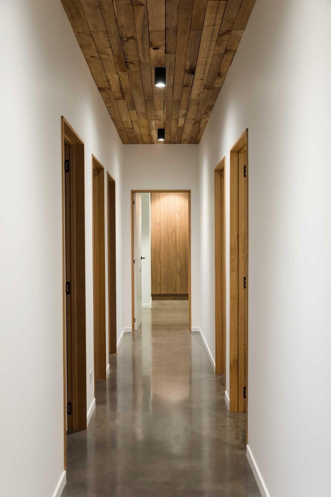 Blackwood House interiors with burnished concrete floors, Blackwood timber ceiling and Tas Oak architraves in a rural setting by architect Michael Loubser from Loubser Workshop in Tasmania