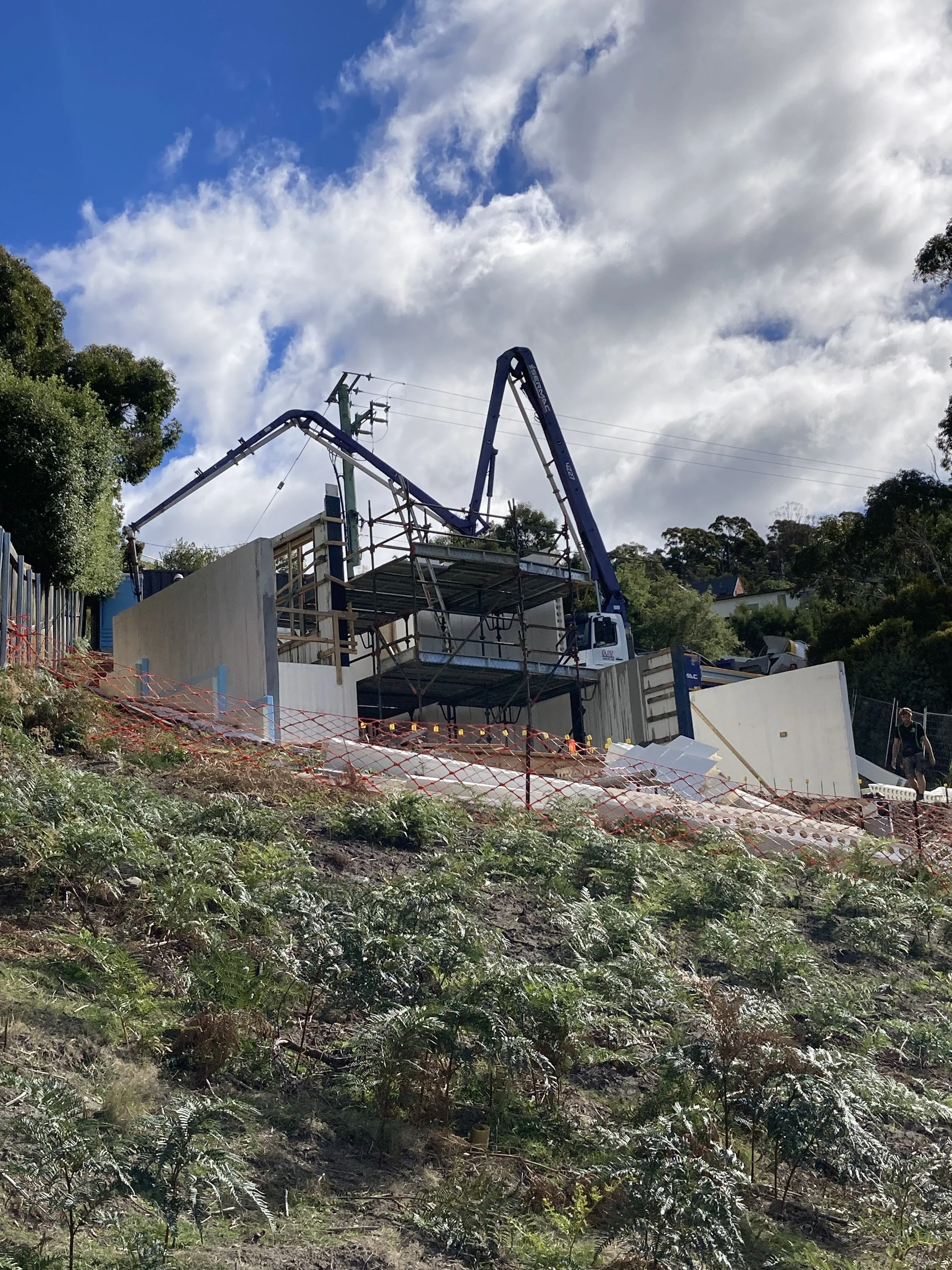 Hobart Hills CLT House. Site construction progress showing Dincel wall installation and concrete pump