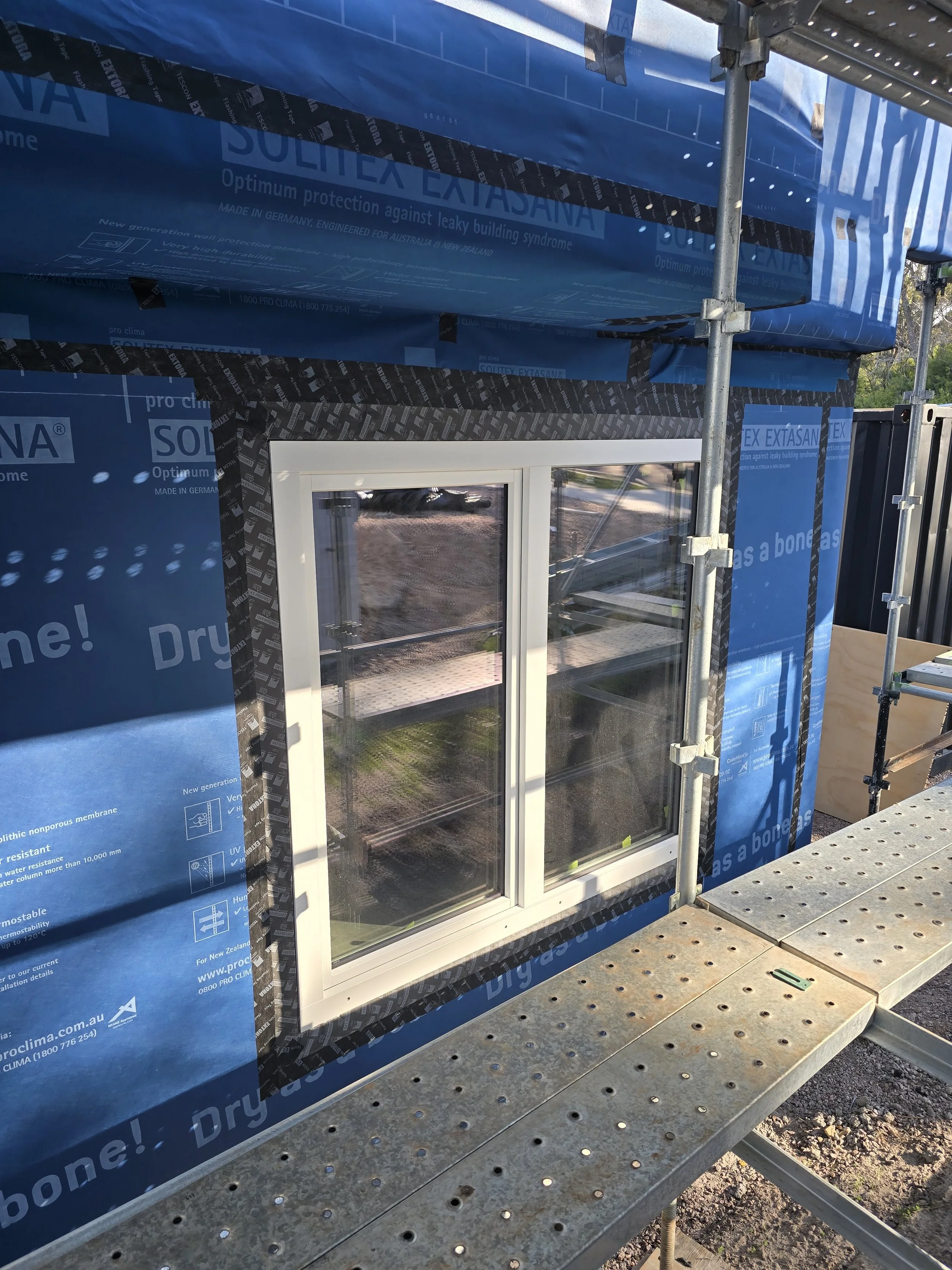 Ocean View Passivhaus. Triple glazed UPVC Aluclad window installation. Unilux Windows