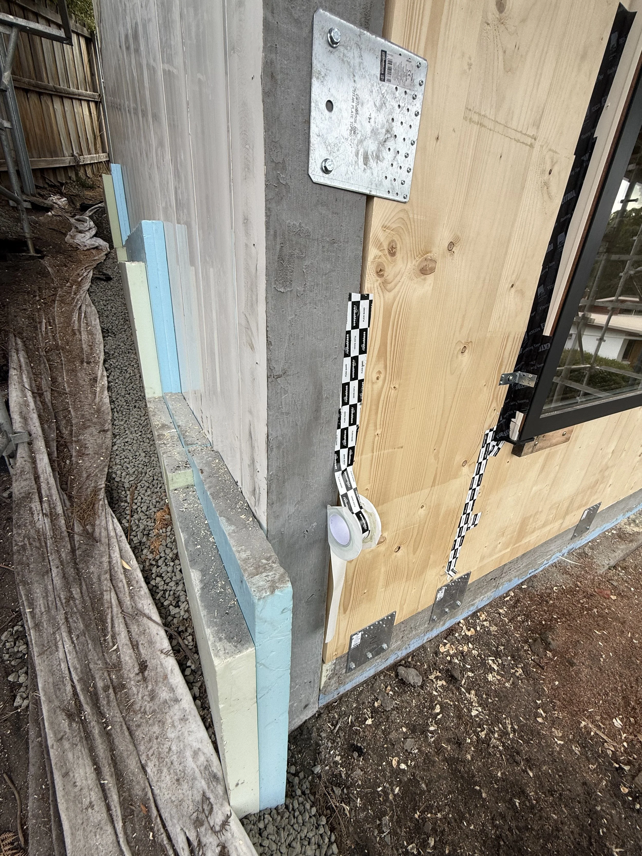 Hobart Hills CLT House. Site construction progress showing Dincel, CLT and insulation junction by Loubser Workshop