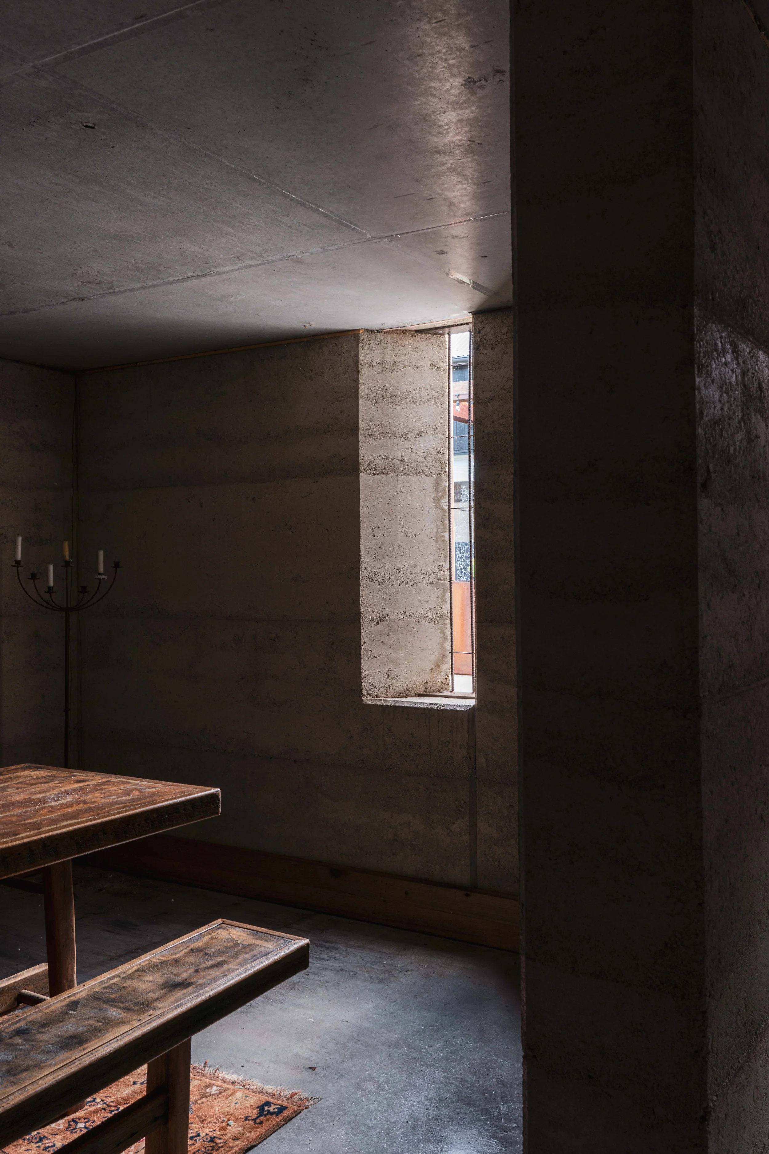 Bicheno Beach House wine cellar interior with rammed earth in a rural coastal setting by architect Michael Loubser from Loubser Workshop in Tasmania