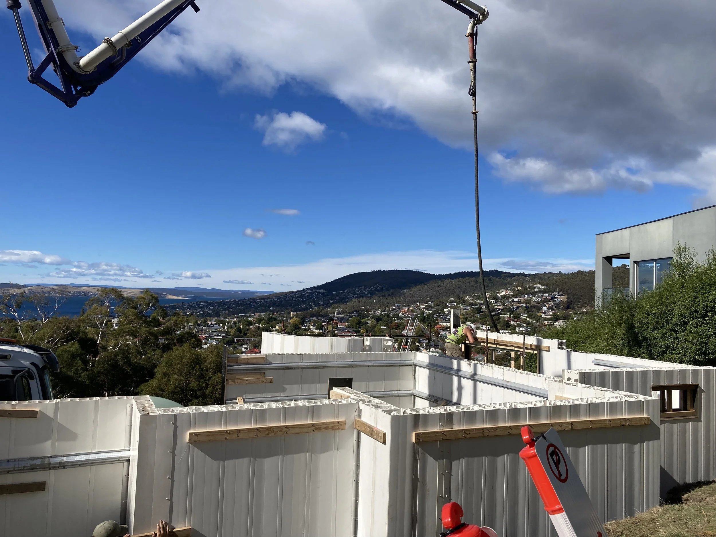 Hobart Hills CLT House. Site construction progress showing Dincel wall installation and concrete pump