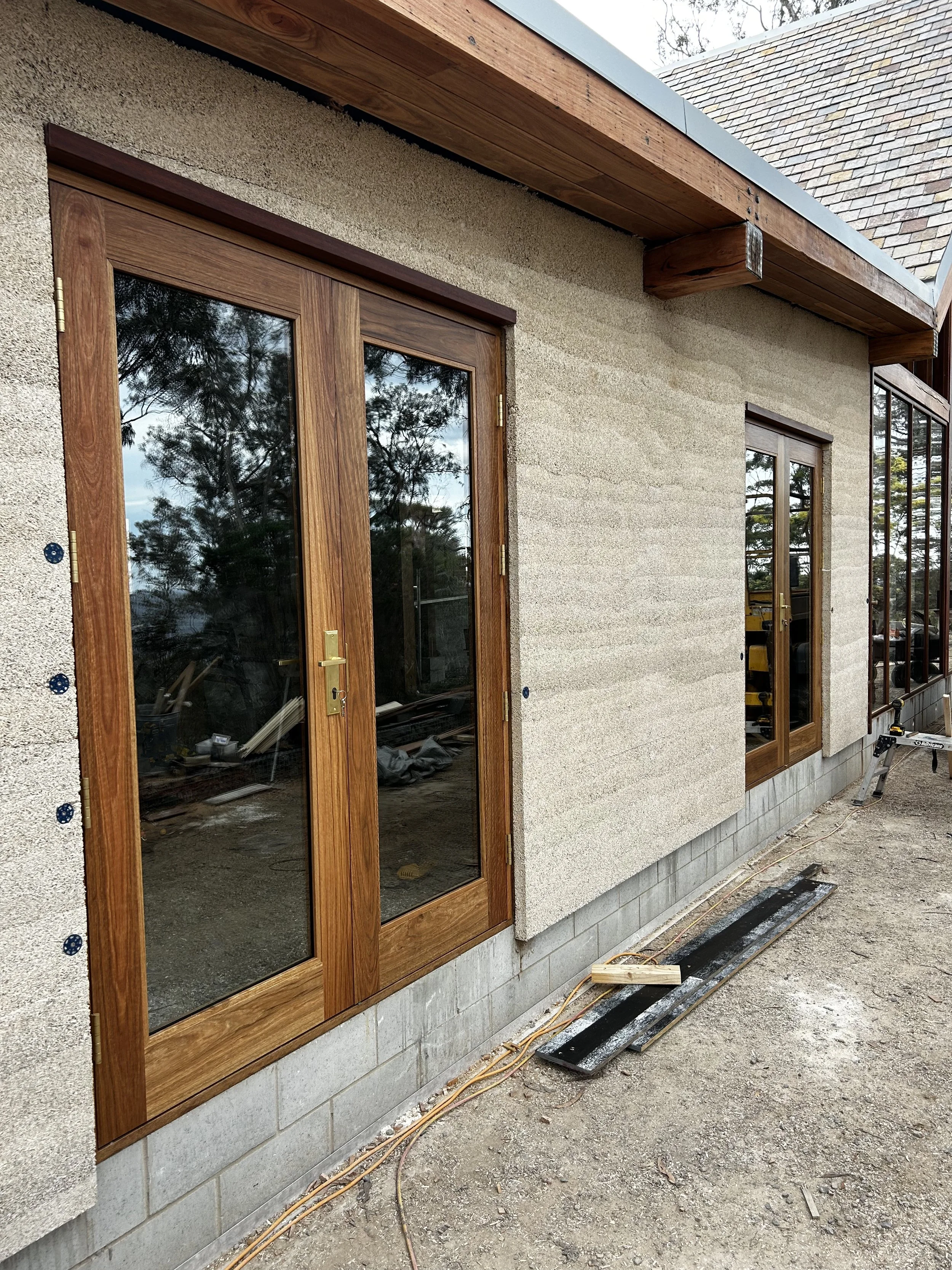 Bicheno Bushbuck. Construction progress. Spotted gum timber french doors installed. Double glazed Bushfire rated