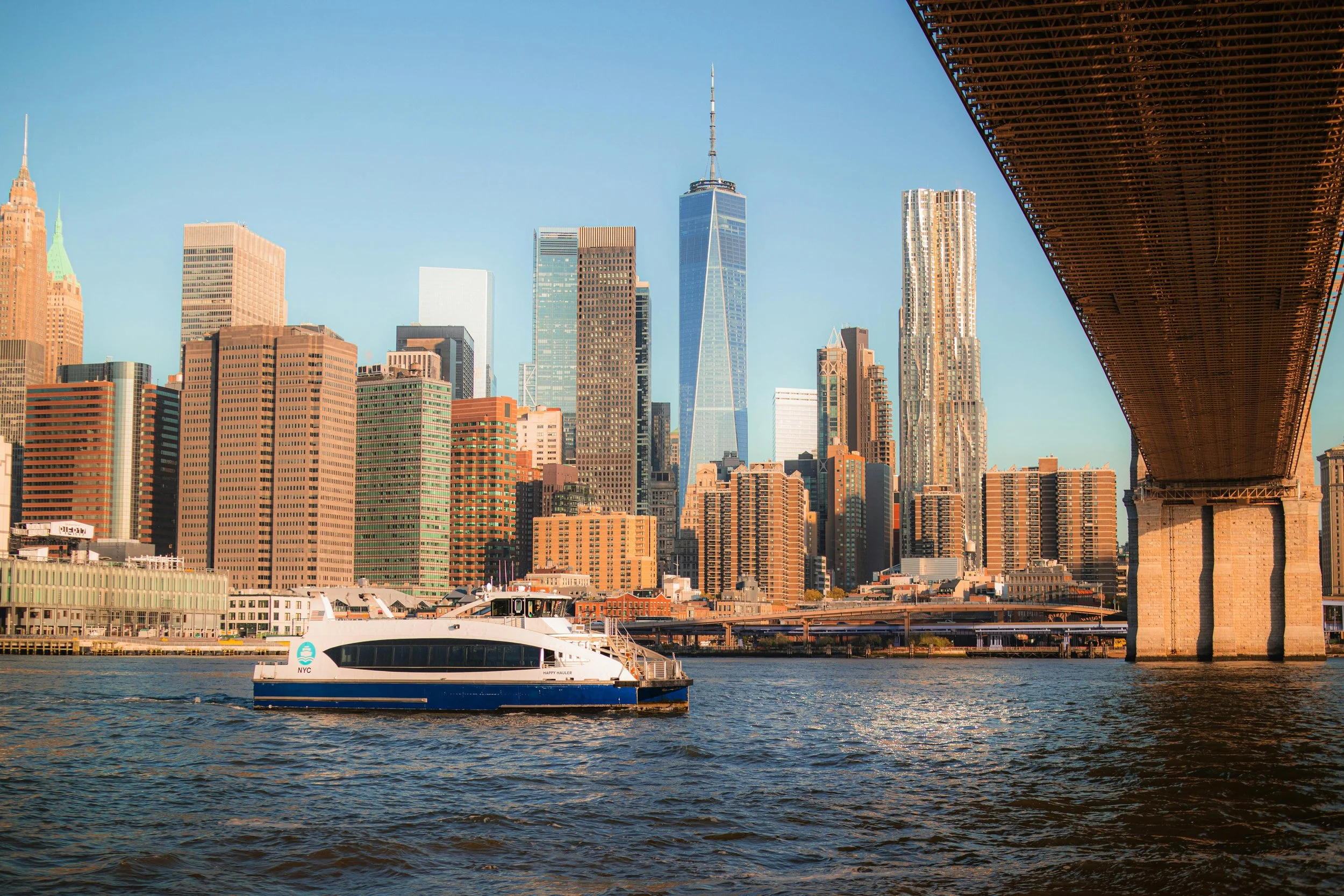 free-photo-of-nyc-ferry-by-iconic-manhattan-skyscrapers.jpeg