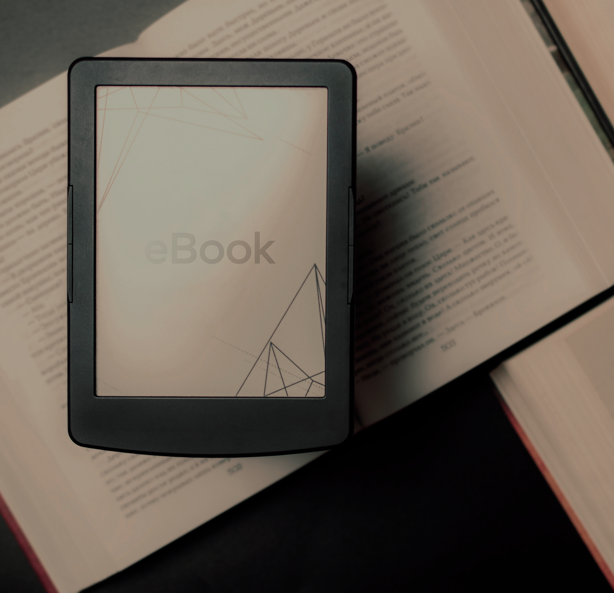 E-book reader on top of open books