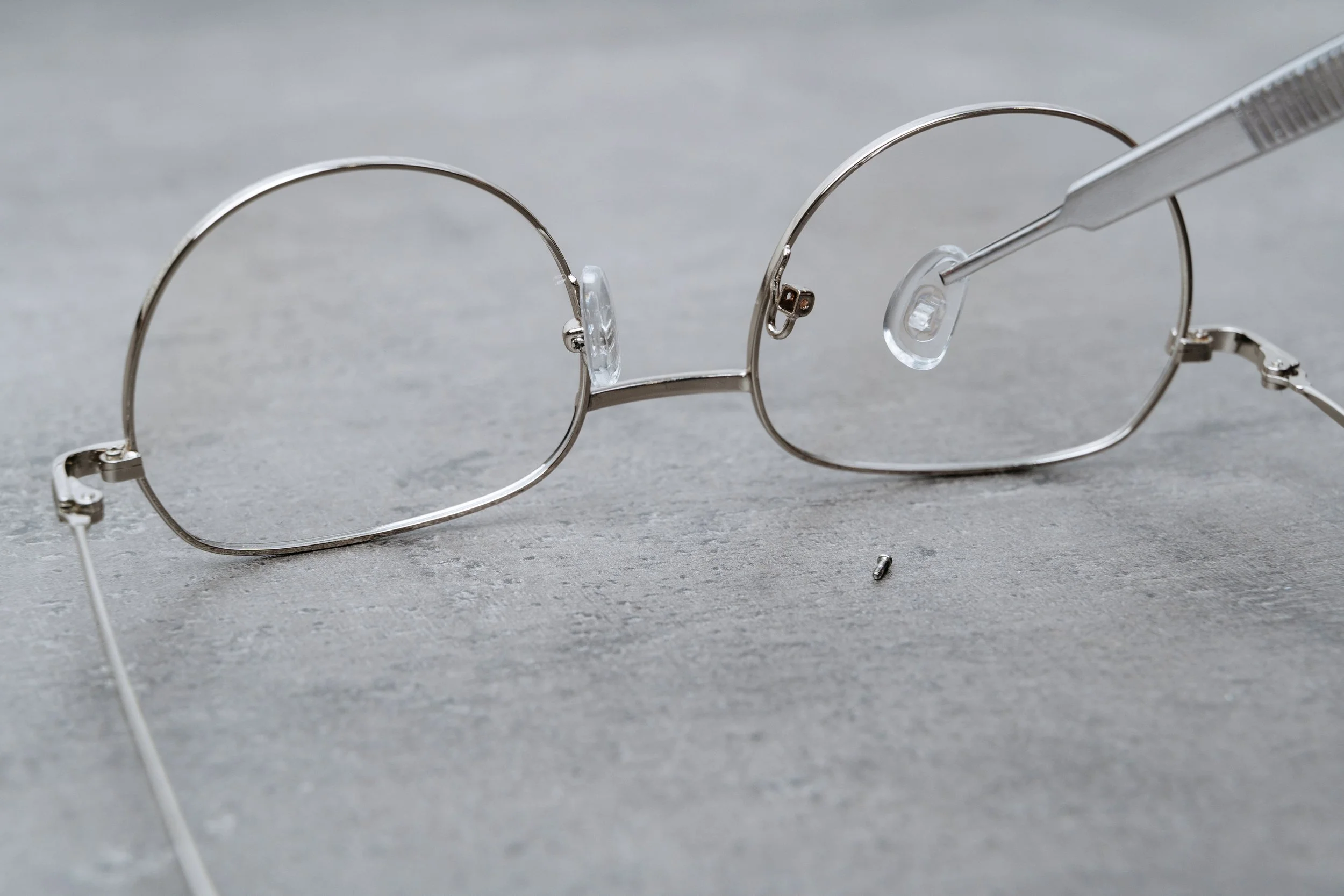 A pair of broken spectacles being repaired