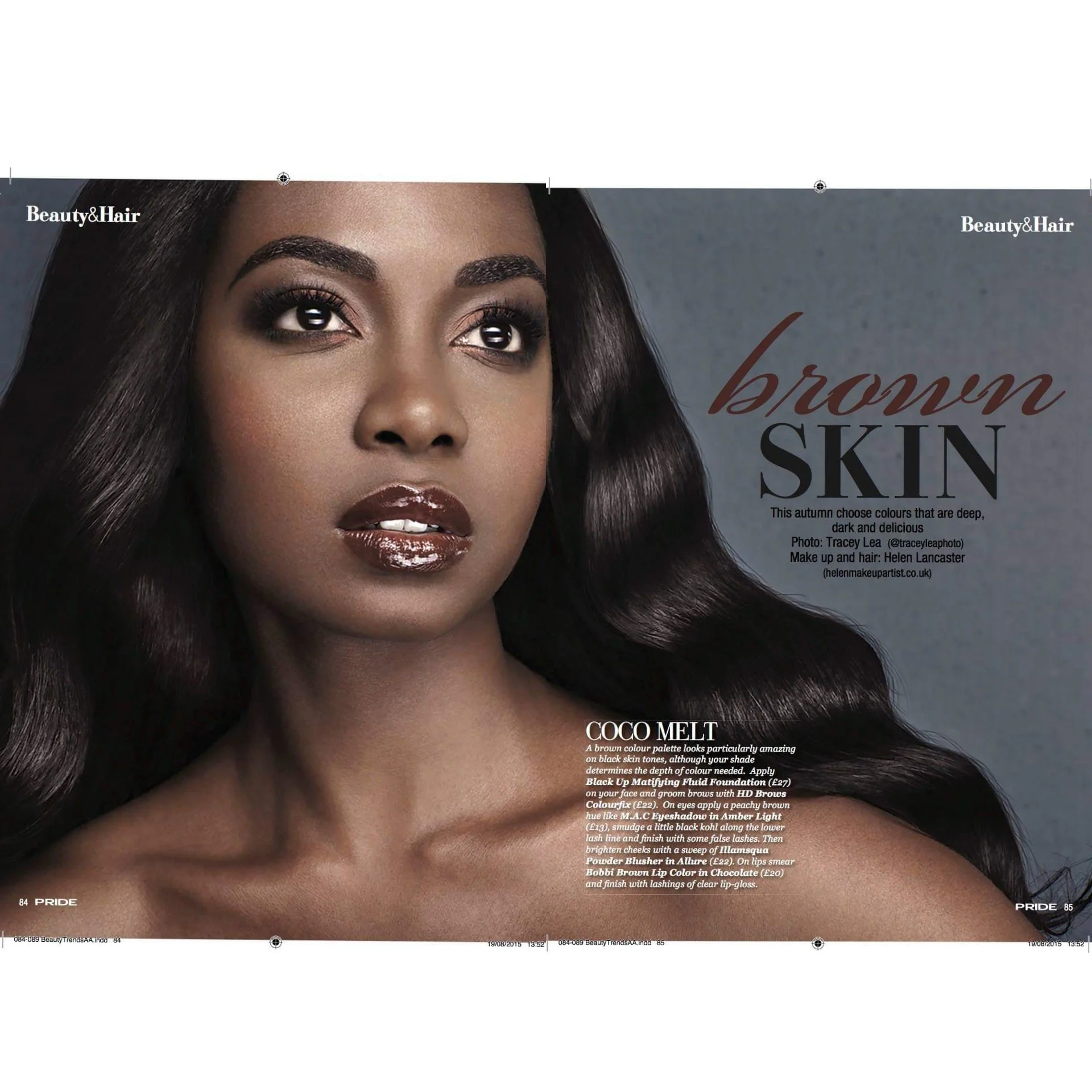 Close-up of a woman with dark brown skin, shiny dark brown lipstick, black wavy hair, and makeup highlighting her eyes and cheekbones, on a magazine spread about brown skin tones.