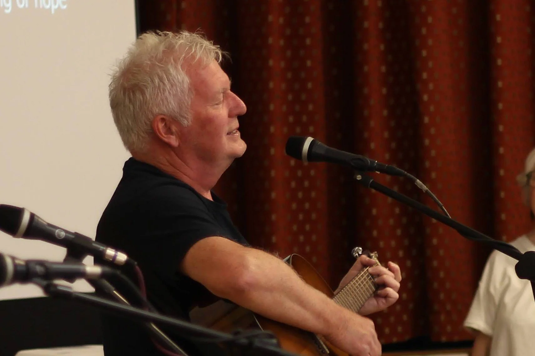 worship leader singing and playing guitar