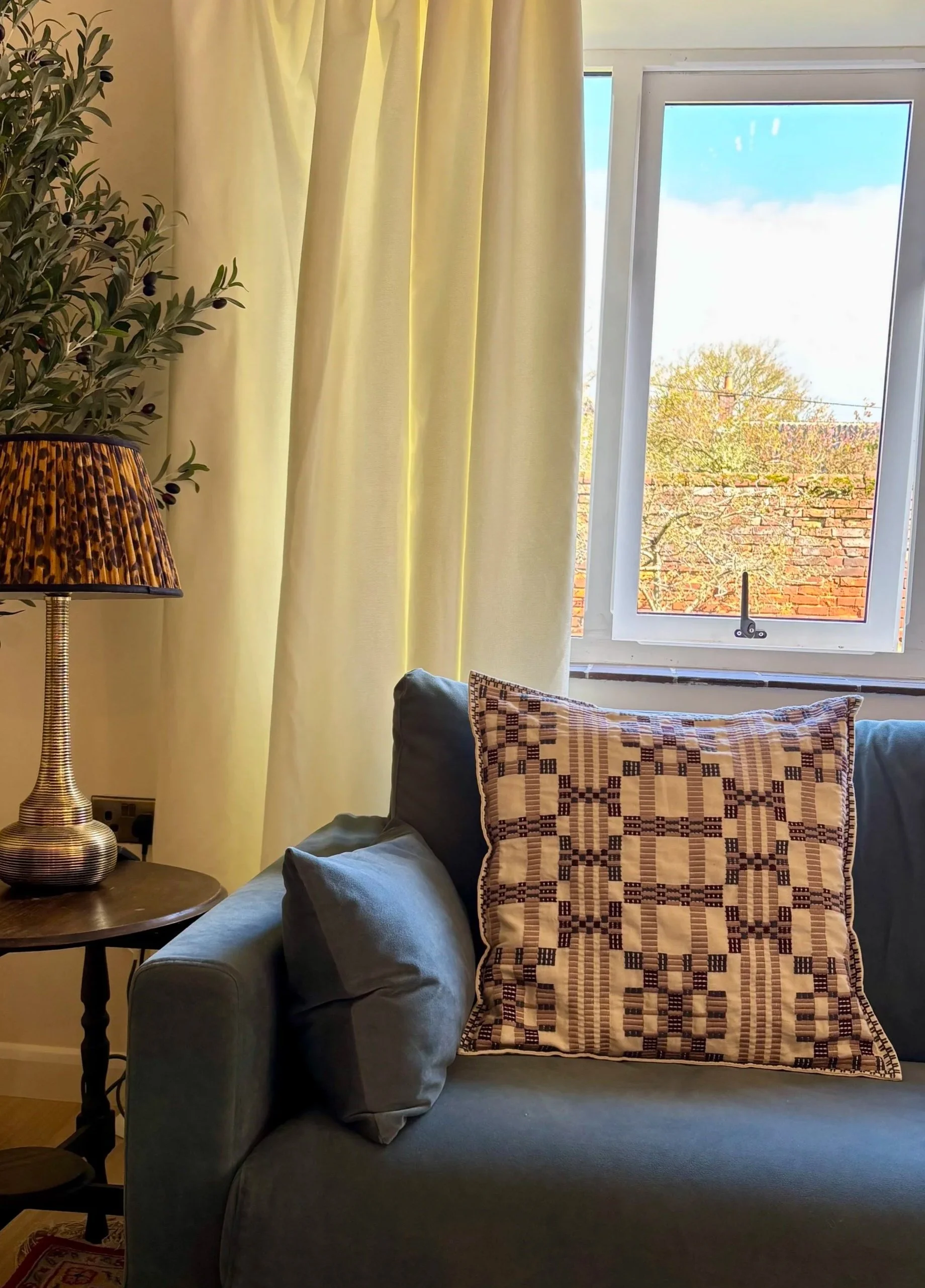Sofa with side table and olive tree