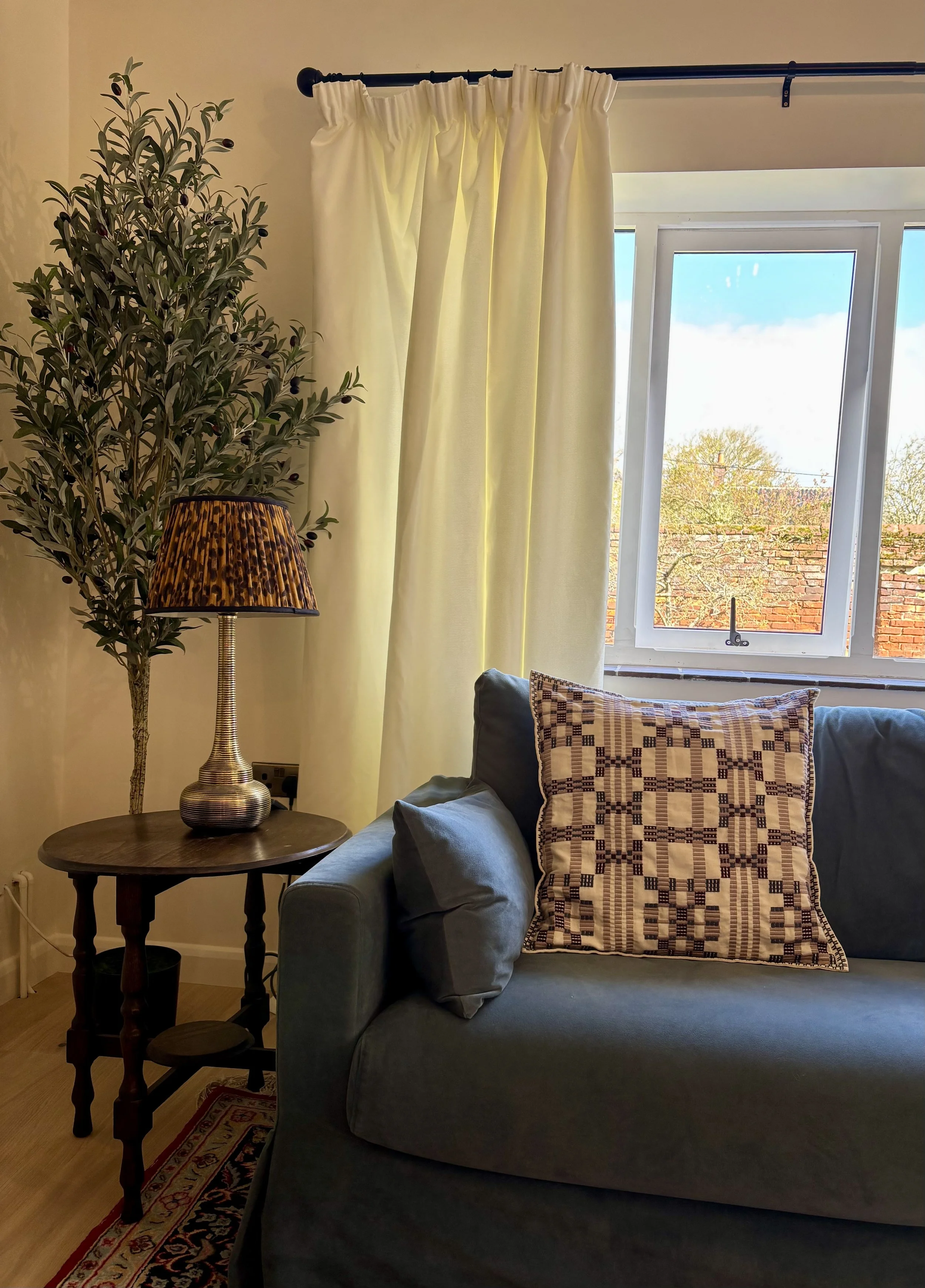 Sofa with side table and olive tree