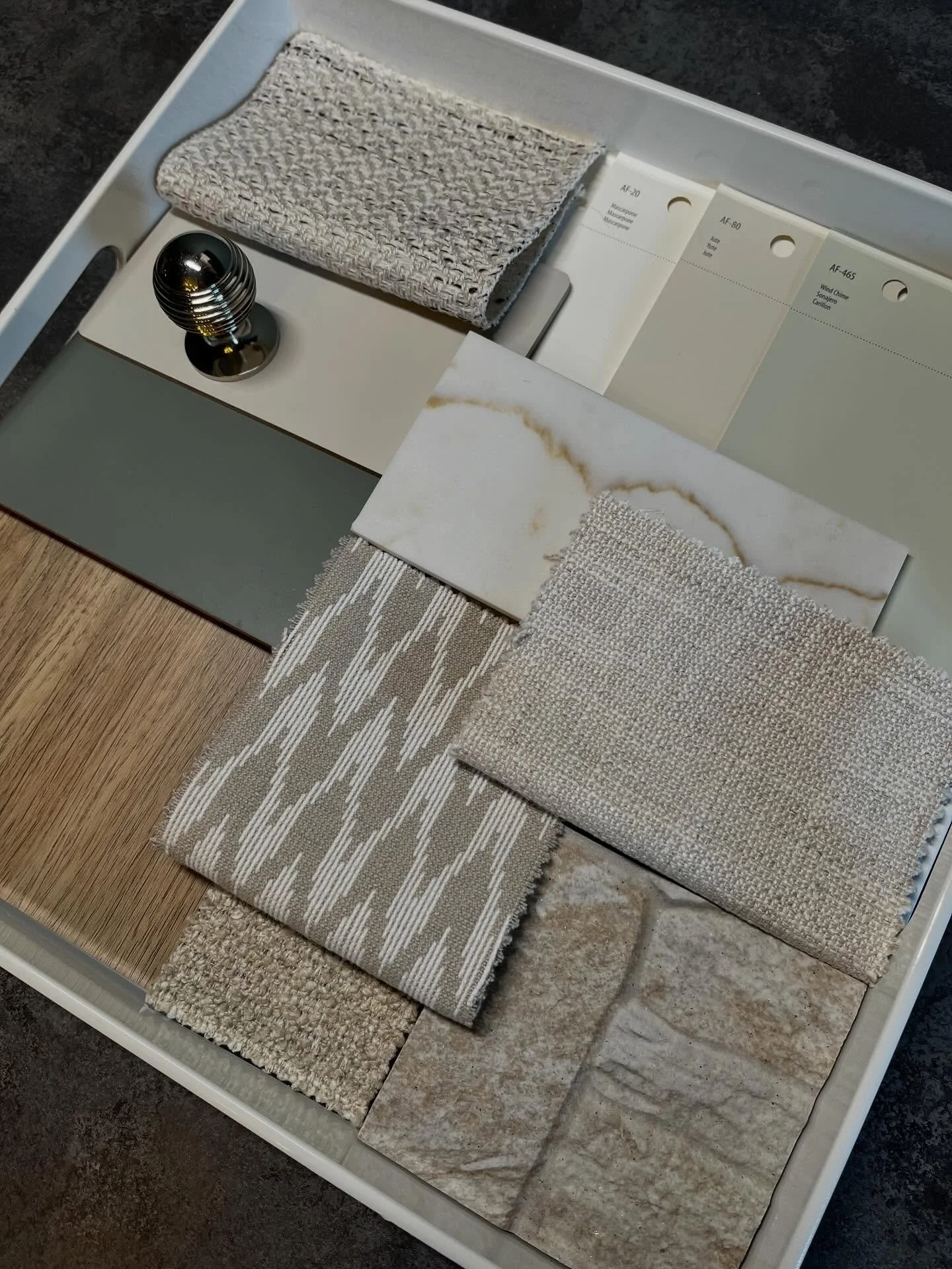 A modern farmhouse palette built on warmth, texture, and understated elegance. Soft woven fabrics, warm oak tones, and subtle marble veining pair with muted sage and creamy neutrals to create a calm, grounded feel. Layered materials add depth while c