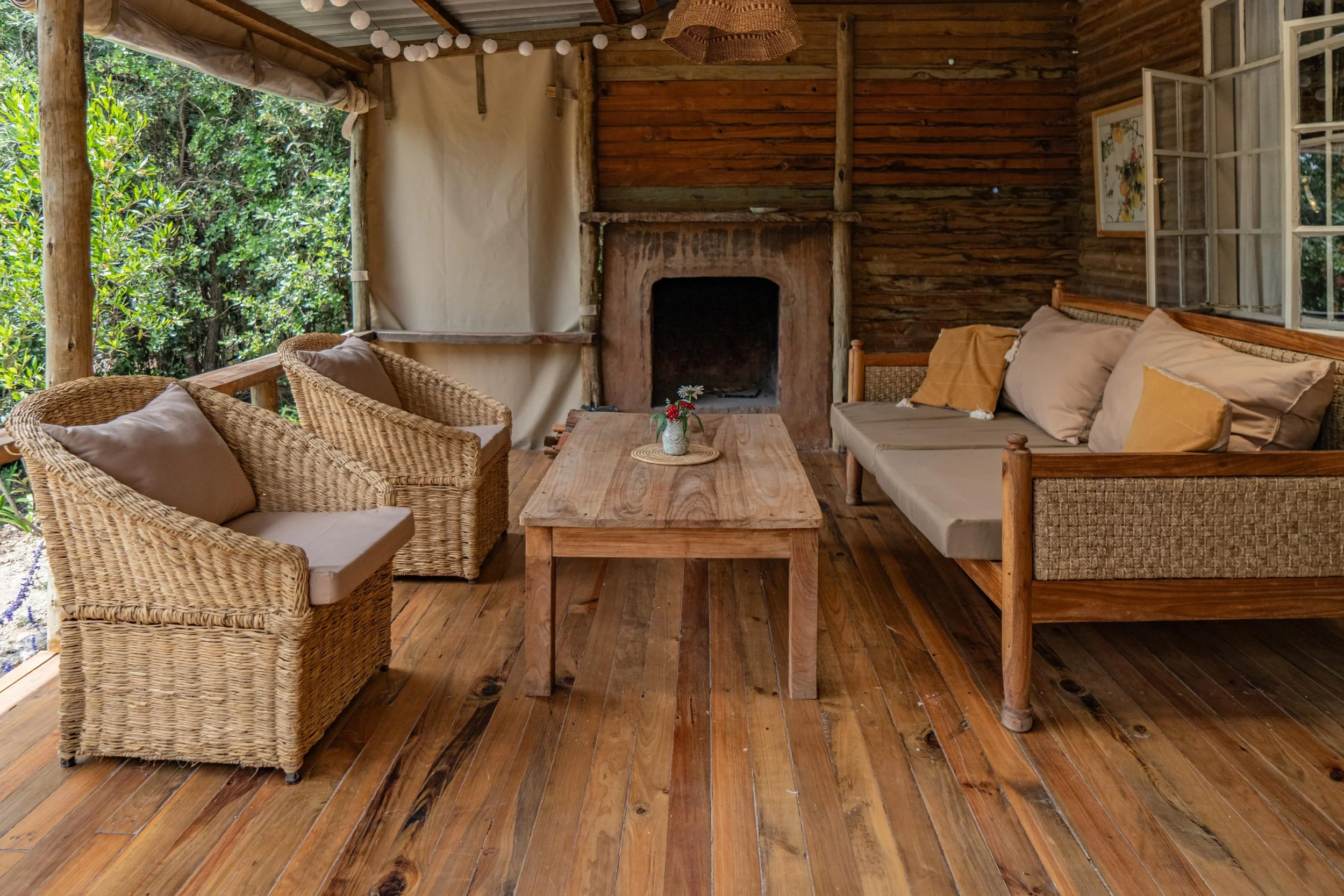 Cozy veranda with fireplace and roll-down canvas for cooler evening