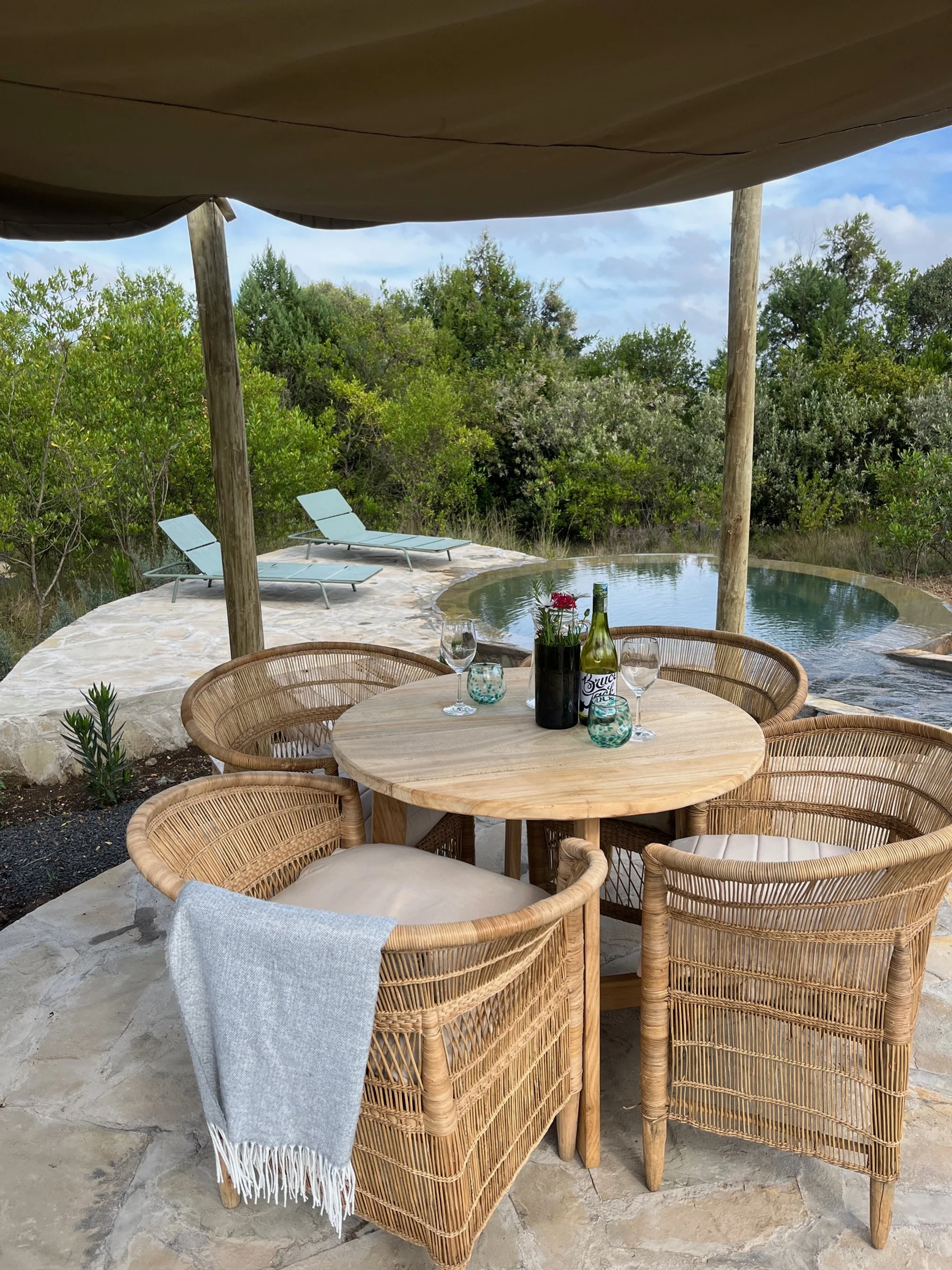 Shared swimming pool with sunbeds and eating area