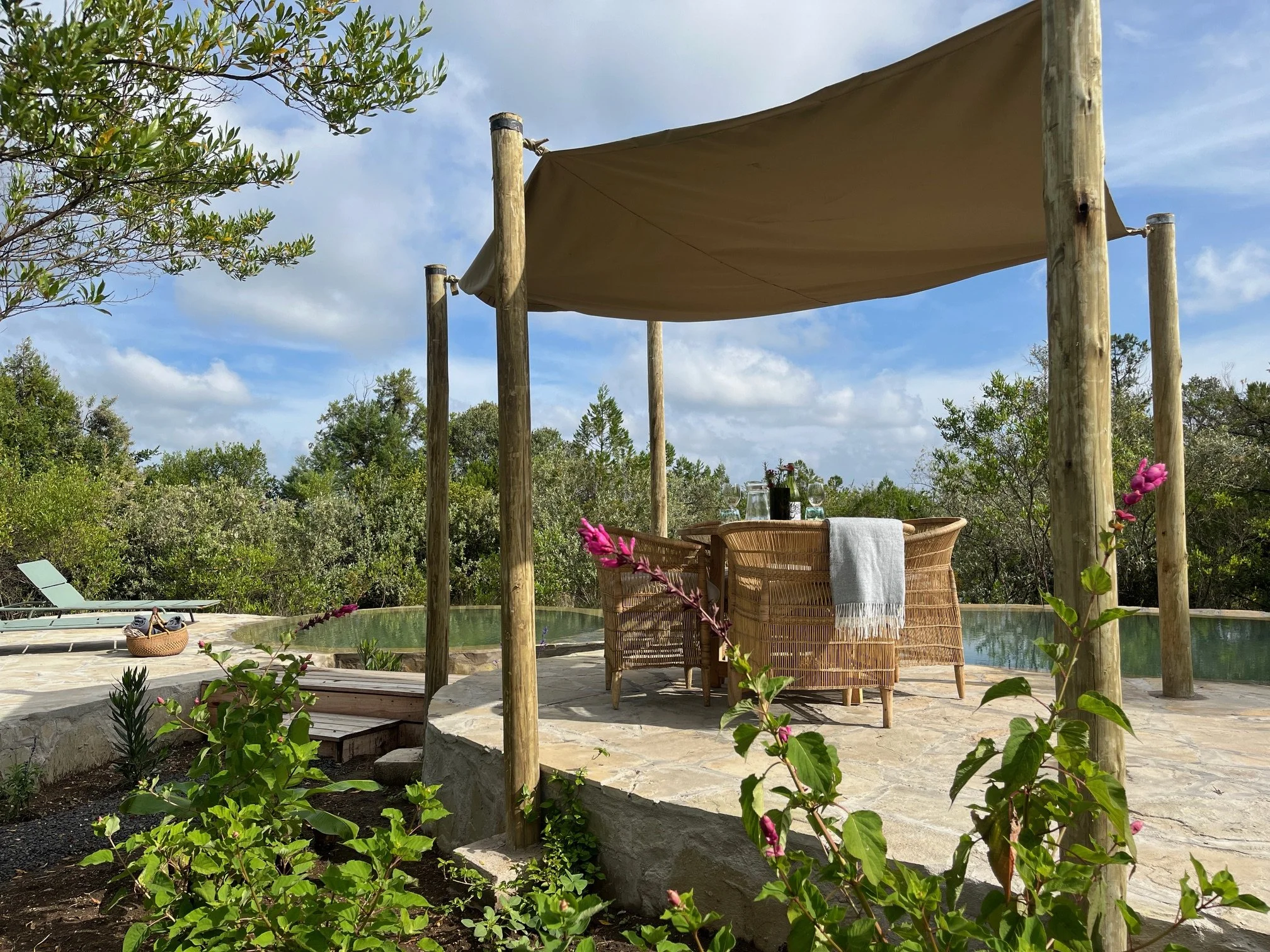 Shared swimming pool with sunbeds and eating area