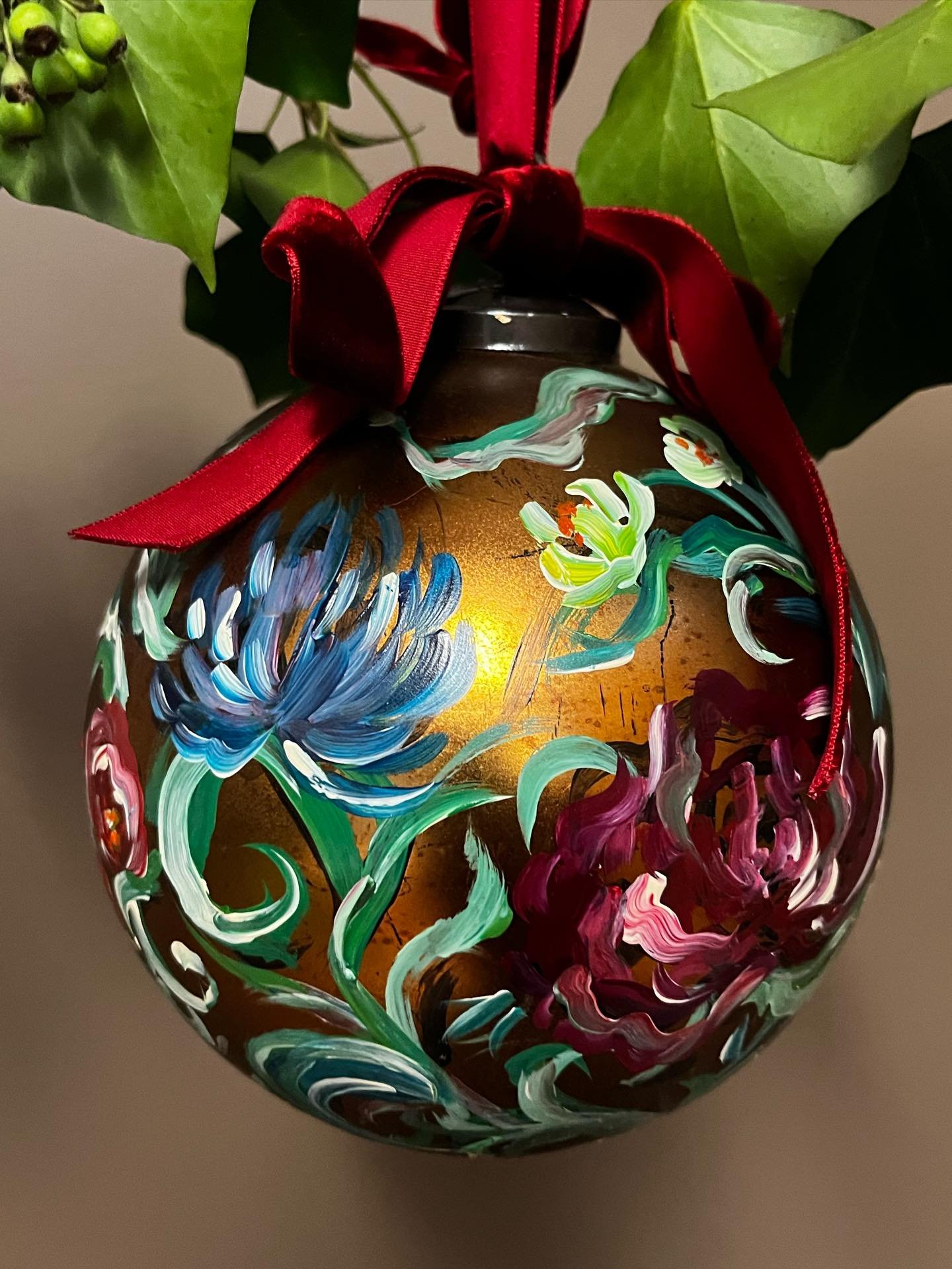 Festive Floral Bauble - Amethyst 
.
This recycled gold glass bauble is carefully hand-painted by Claire, featuring layered florals that give each piece its own unique charm. 
.
Finished with a rich red velvet bow, it brings a touch of luxury to your 