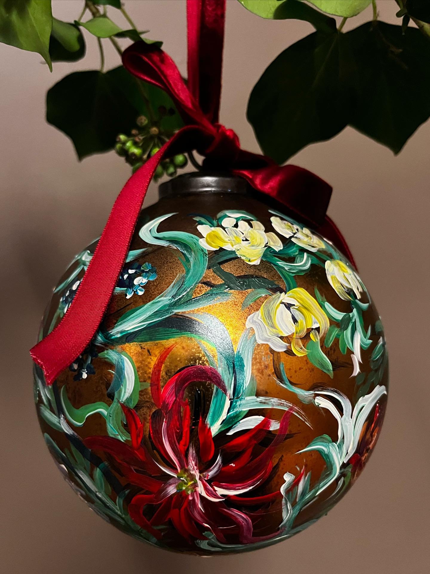 Festive Floral Bauble - Spinel
.
This recycled gold glass bauble is carefully hand-painted by Claire, featuring layered florals that give each piece its own unique charm. 
.
Finished with a rich red velvet bow, it brings a touch of luxury to your Chr