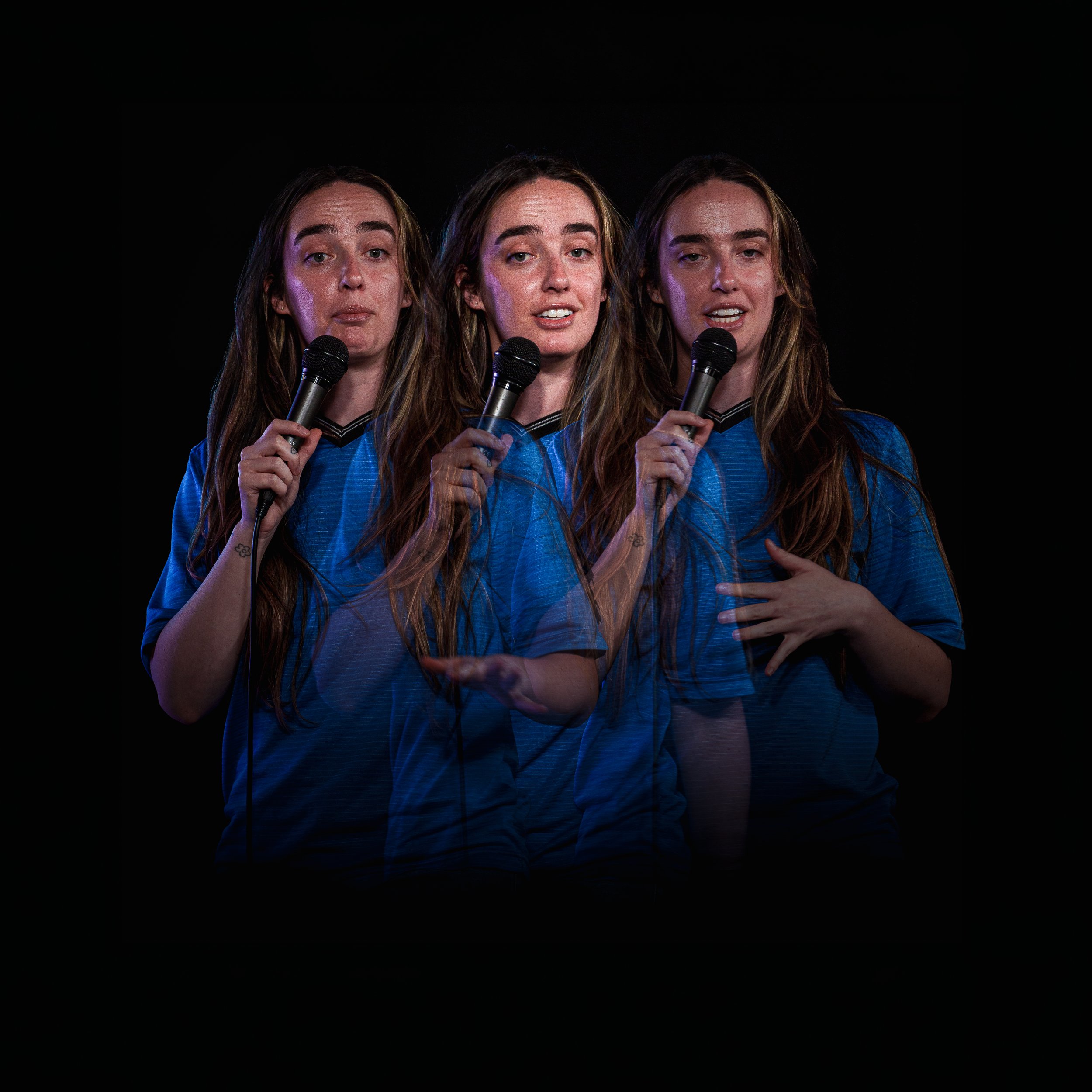 Three women with long hair, each holding a microphone, standing side by side against a black background.