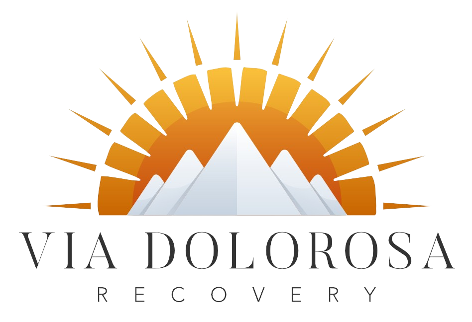 Logo for Via Dolorosa Recovery featuring mountains, a sun with rays, and stylized text