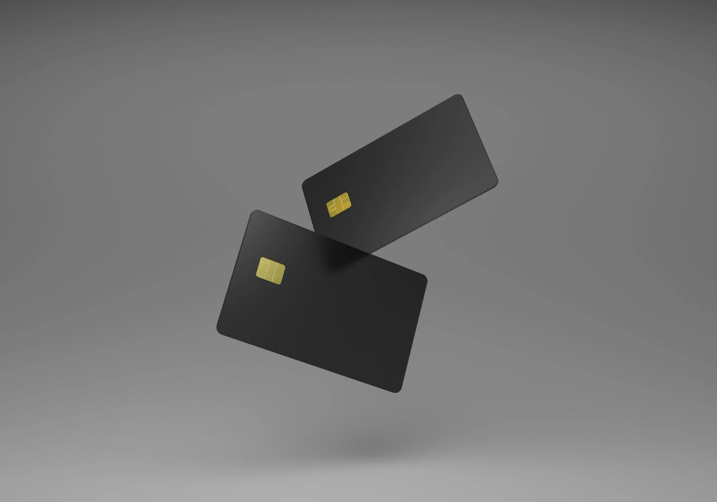 Two black credit cards in the air.