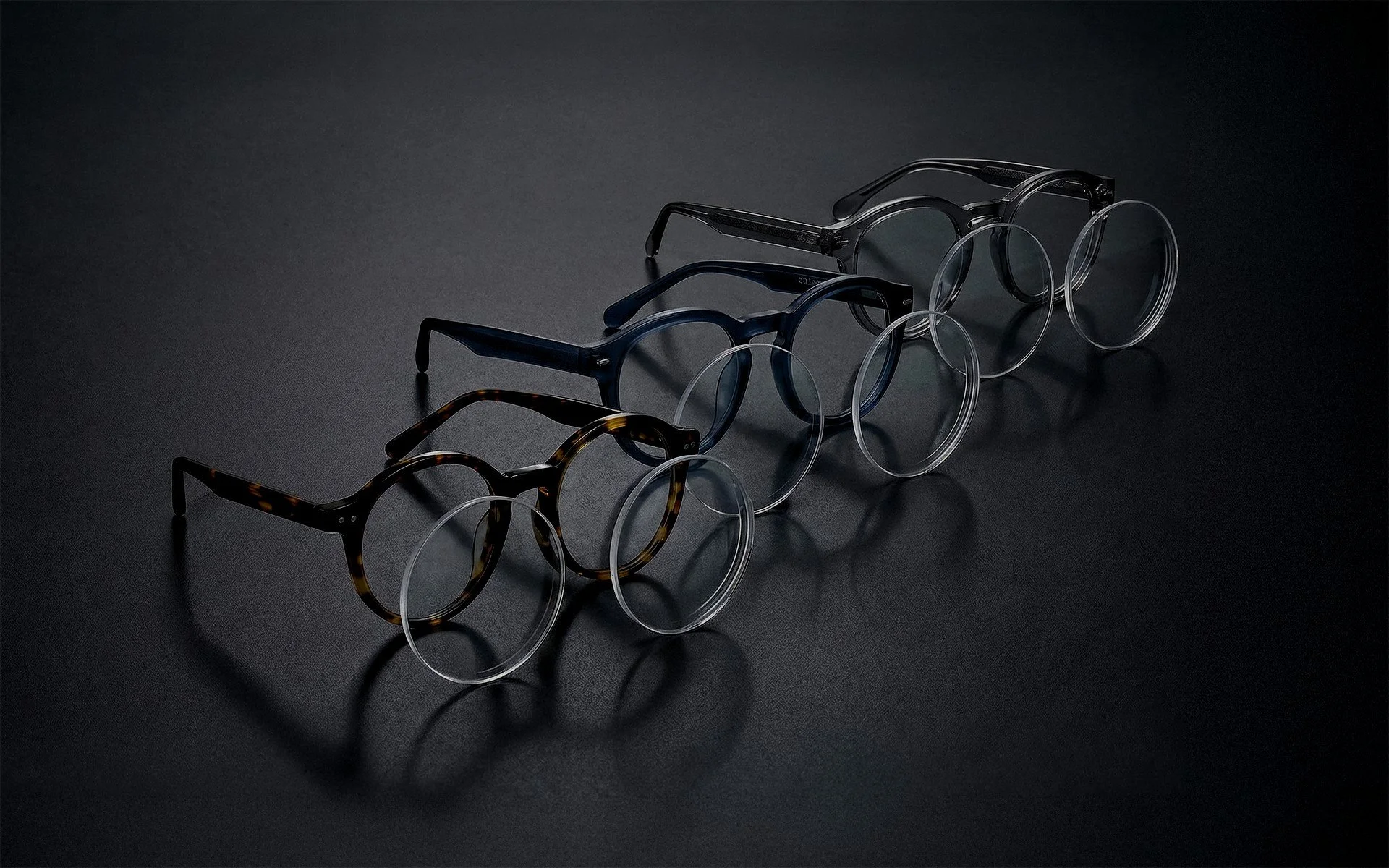 Hand holding a folded hundred-dollar bill against a blue background.