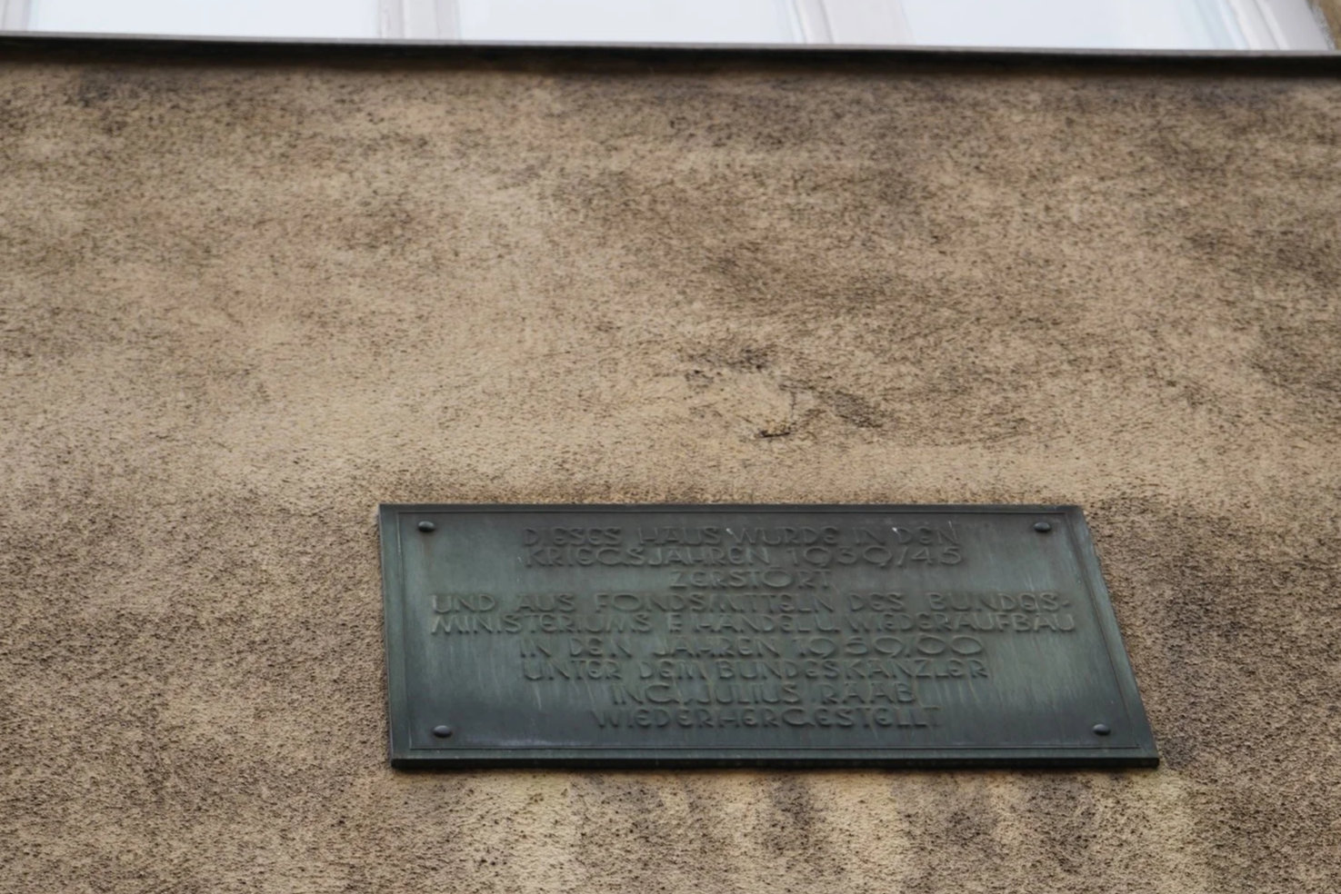 The building was destroyed in the war and rebuilt, which is what the sign says