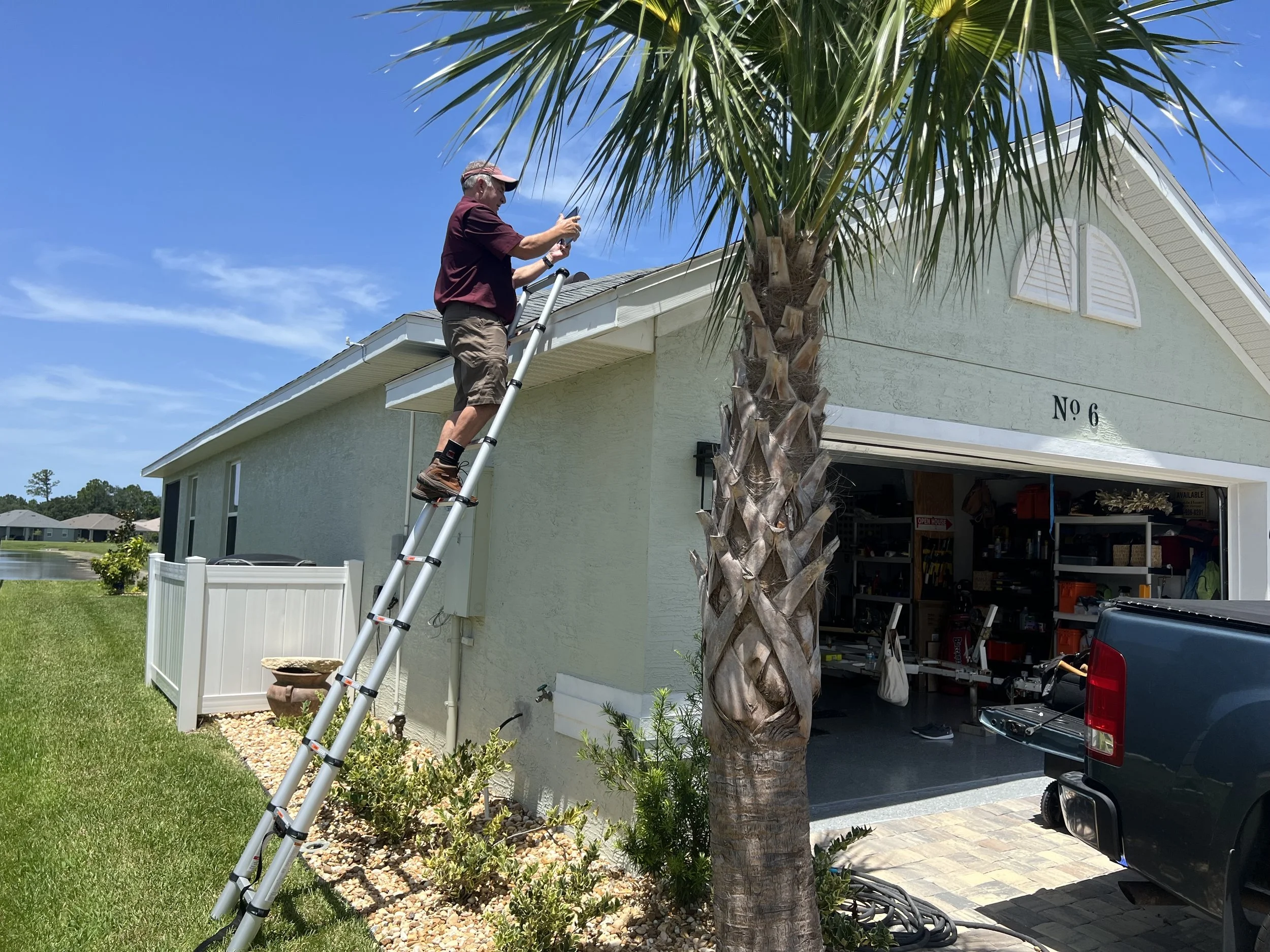 Oranssi technician working on a roof project