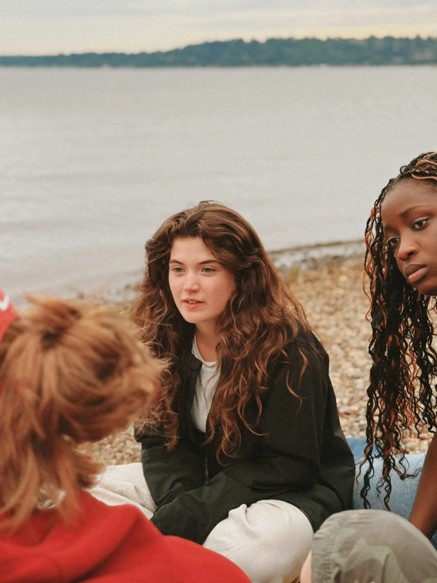 Group of diverse young people talking together at a social gathering, smiling and engaged