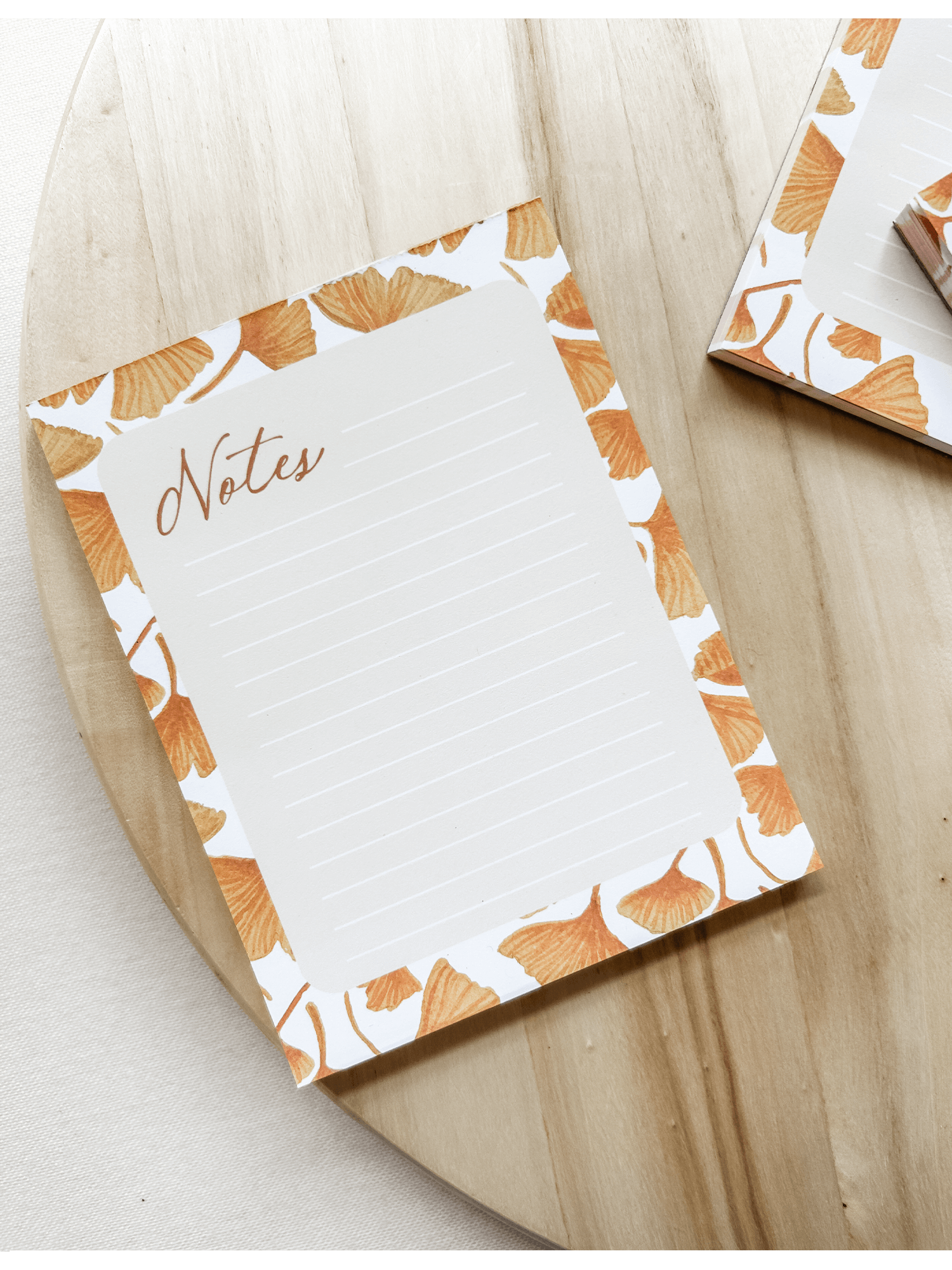 ginkgo-leaf-notepad-yellow-lined-stationery-wood-styled-close-up.png
