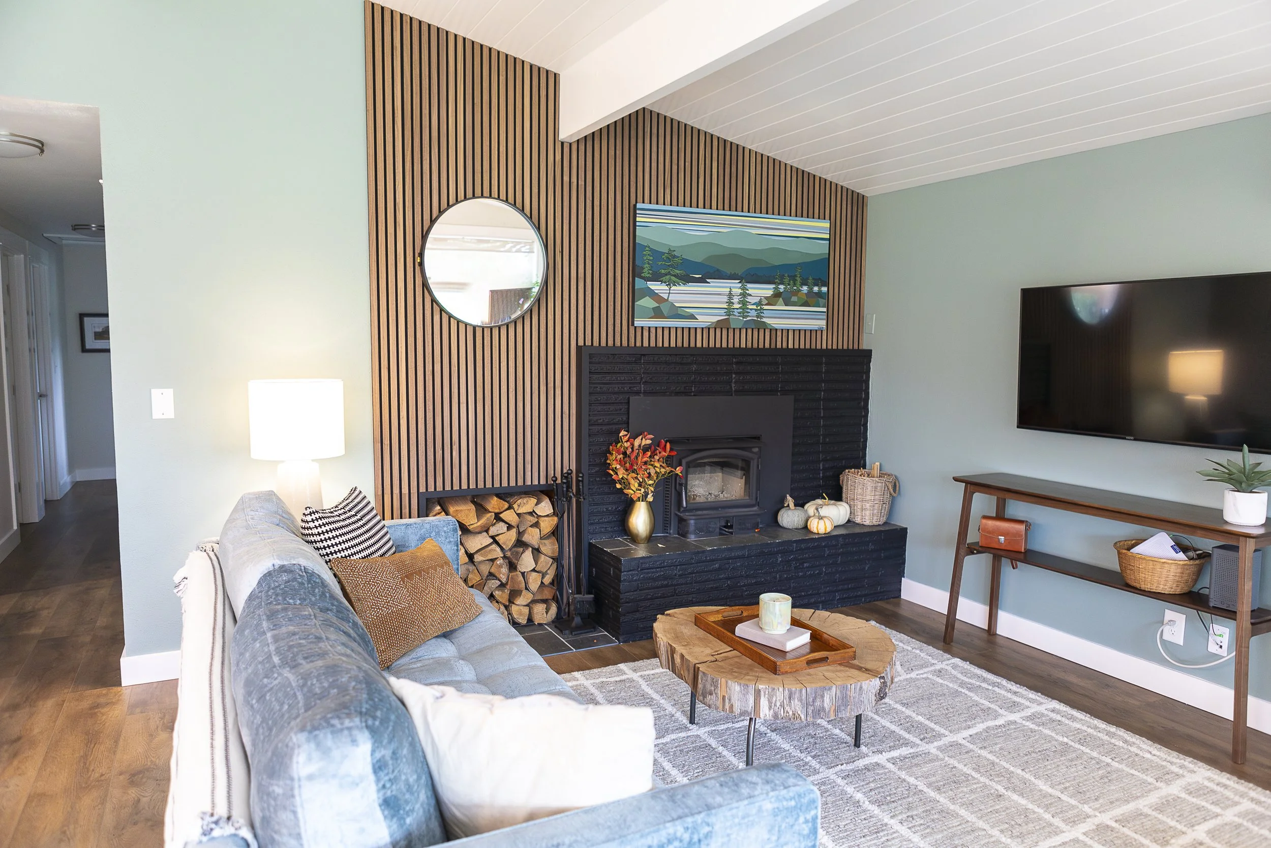 Modern living room with a blue sofa, wooden coffee table. Turnco wood co. Madrona clinton wa. Interior Design. Home Remodel. Interior Designer. Whidbey Island. Whidbey Island interior design. Whidbey Island interior designer.