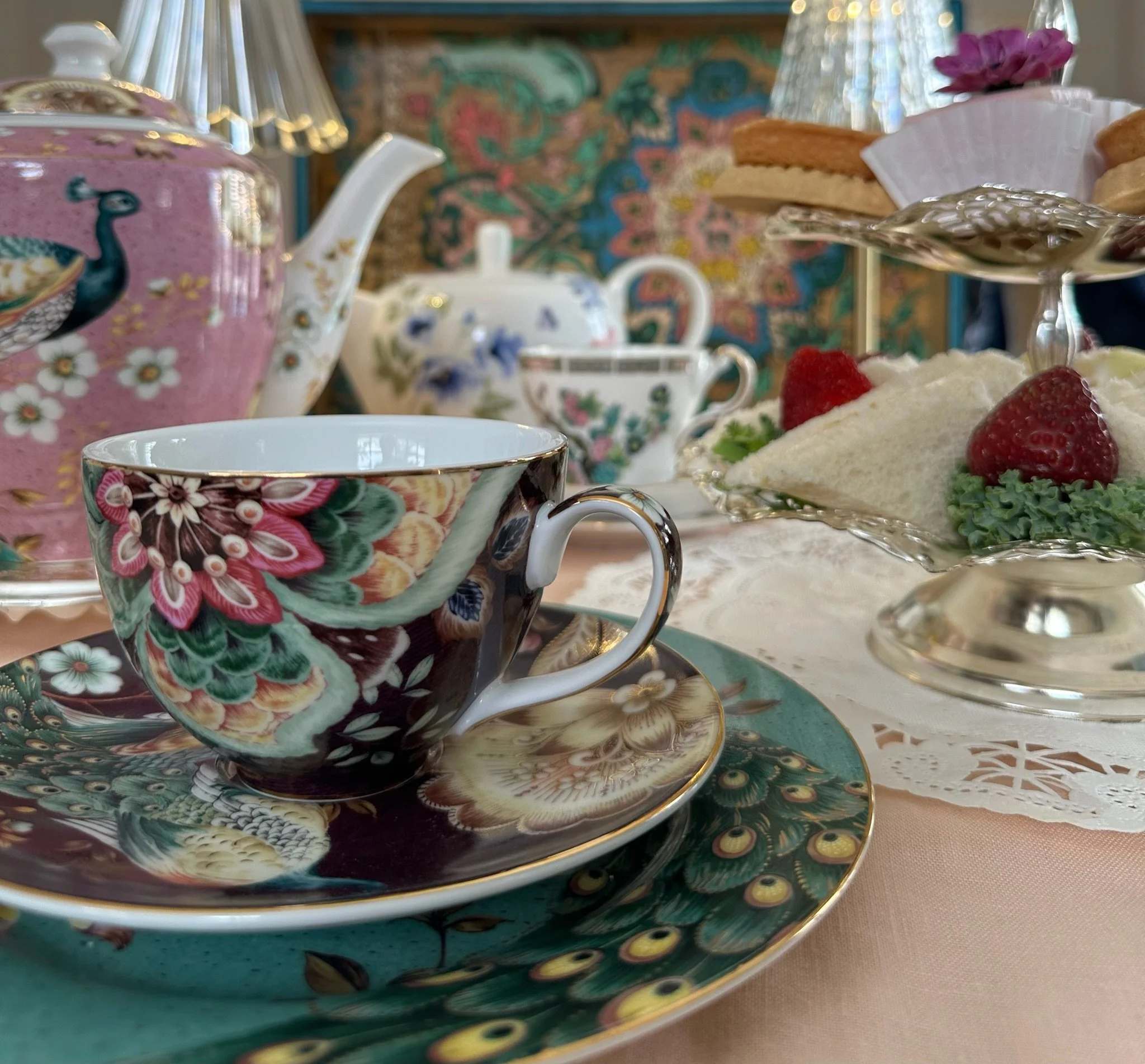 Afternoon tea menu in Monterey featuring tiered stand with sandwiches, scones, and sweet treats