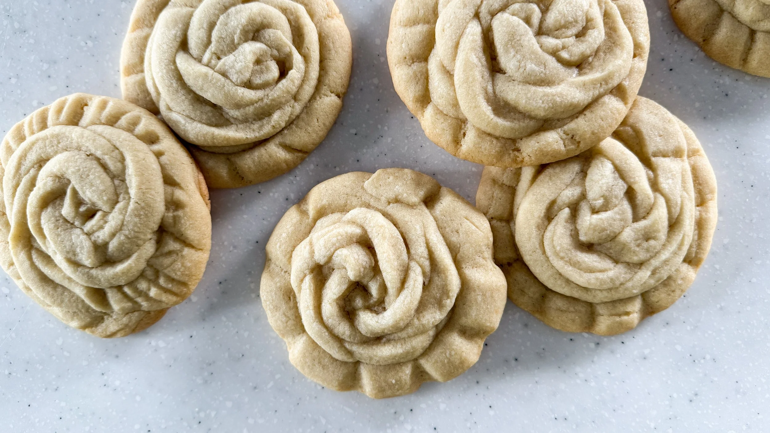 Rose Shaped Sugar Cookies on a white countertop.