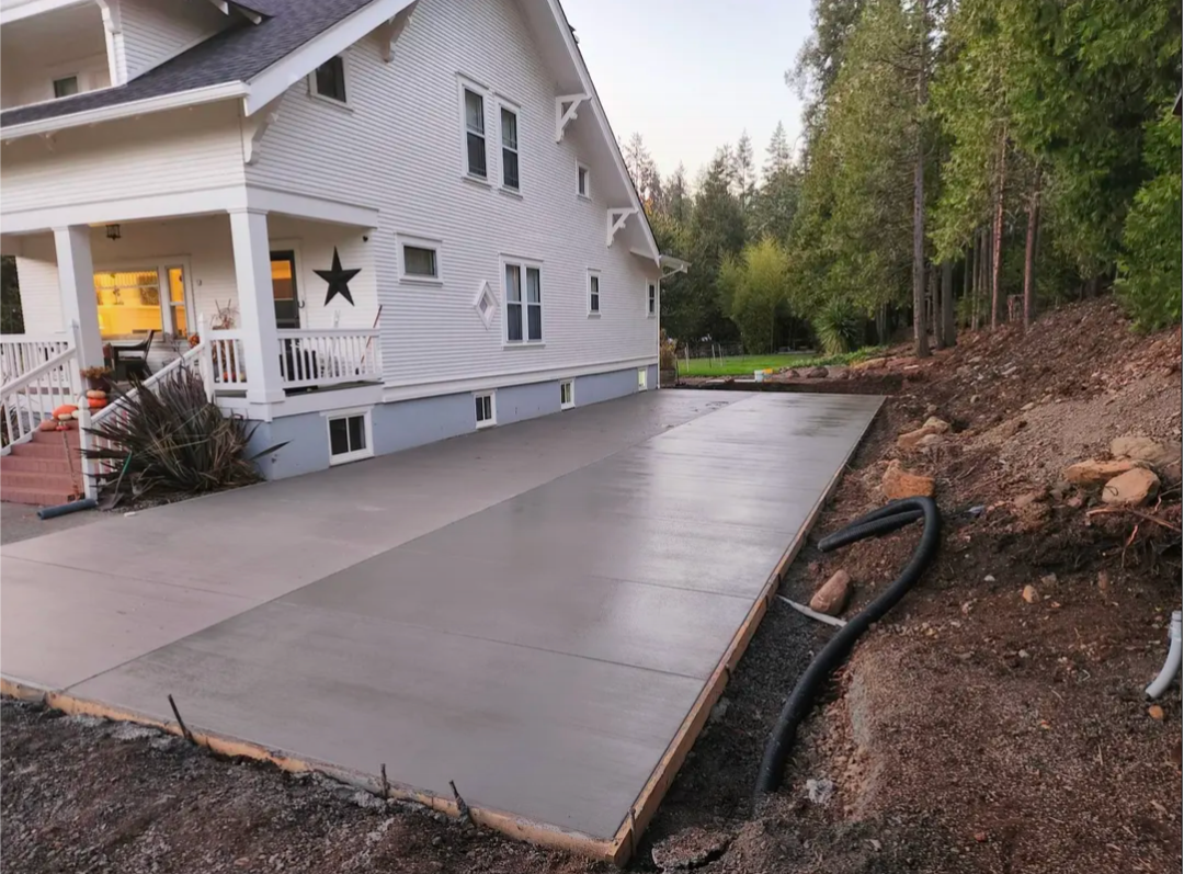 Completed project featuring a finished concrete pad and properly installed drainage system.