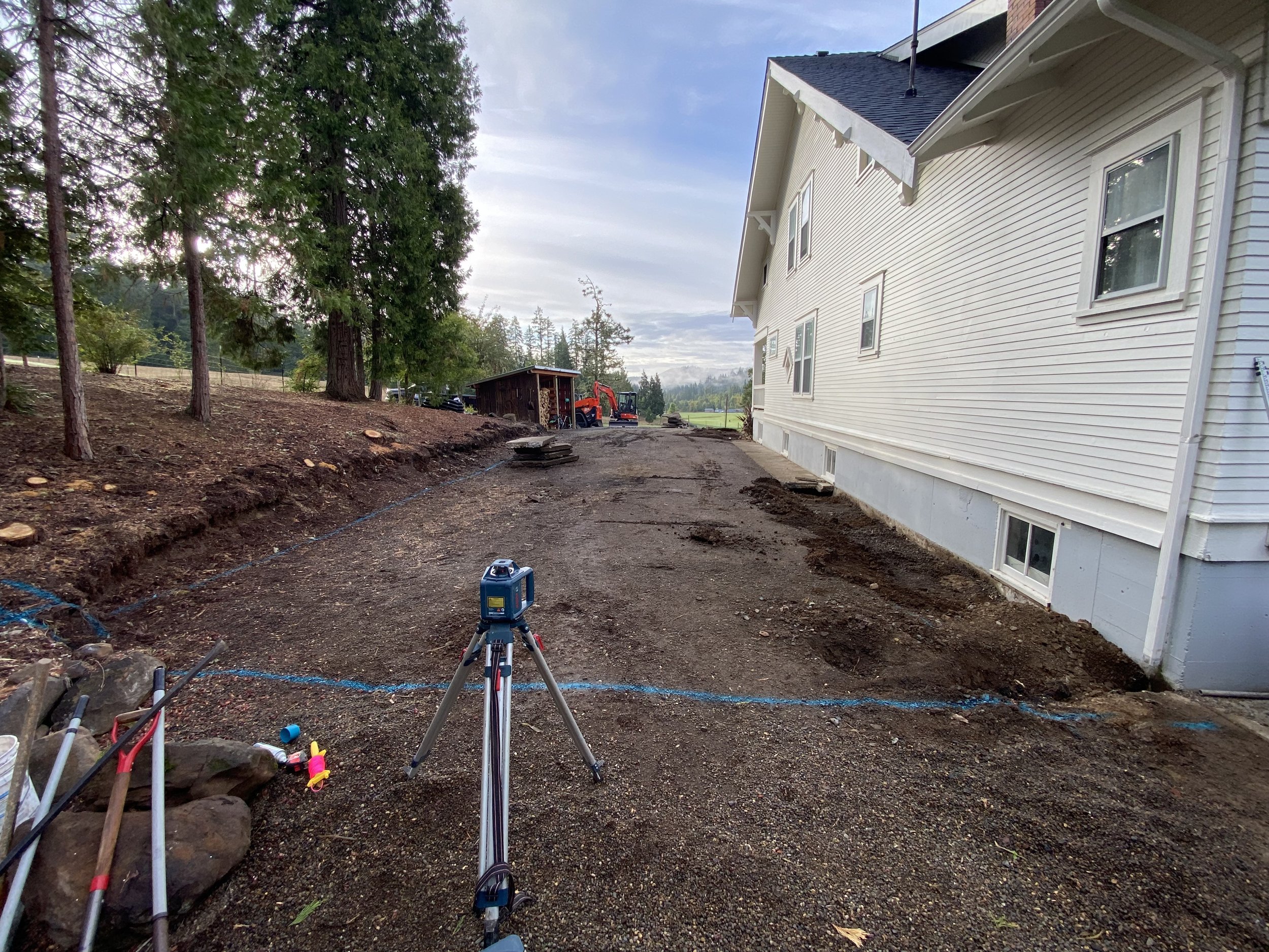 Grading and shaping rock to ensure correct slope and long-term drainage performance.