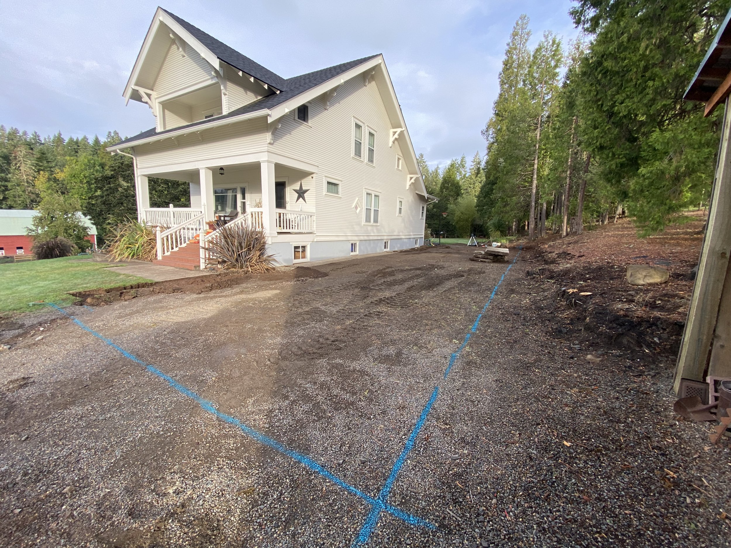 Removed approximately 100 cubic yards of material to establish a stable base for a future concrete slab while improving site drainage.