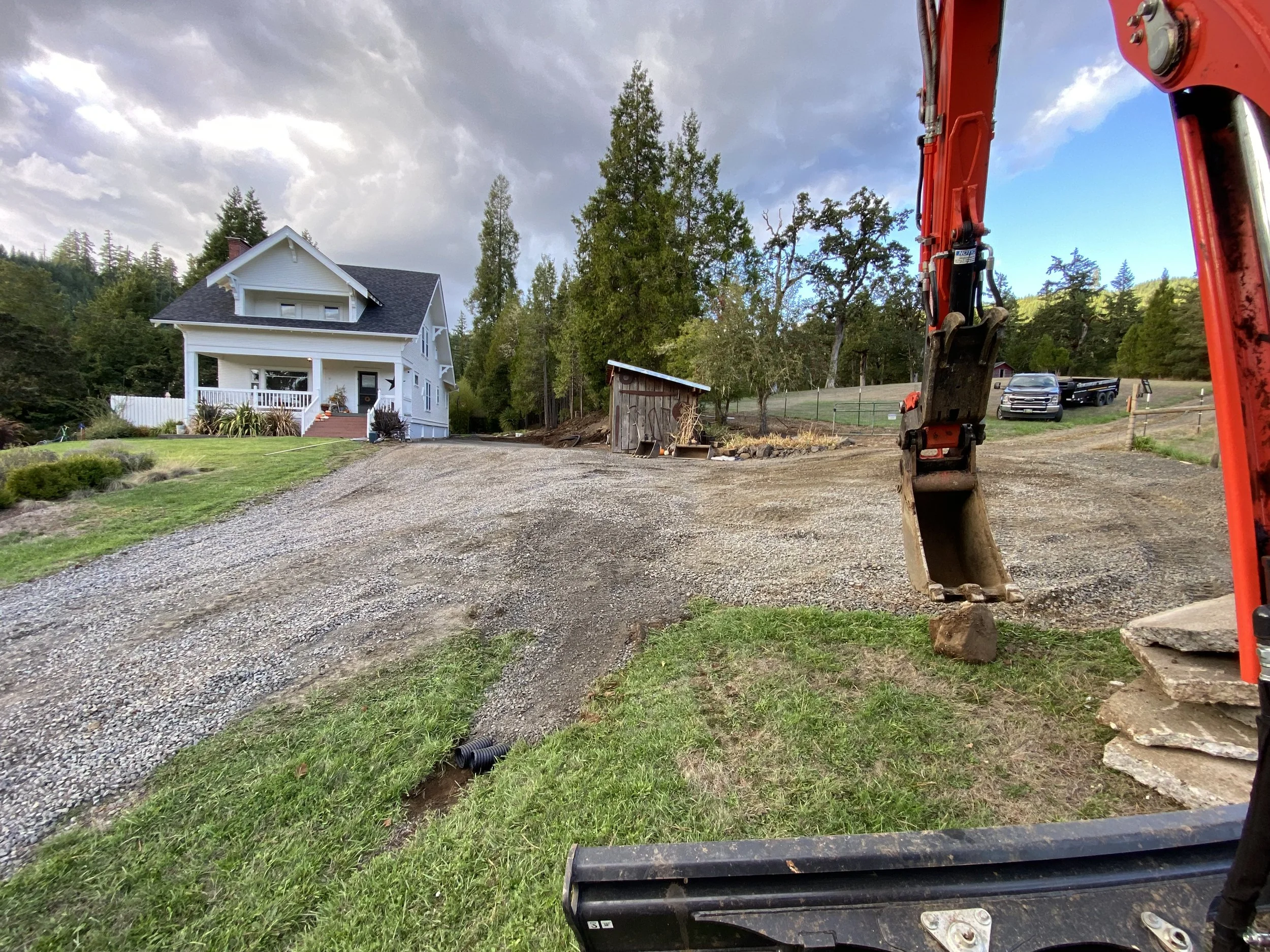 Precision excavation of approximately 100 cubic yards of material to ensure a solid foundation for a future concrete slab and effective drainage solutions
