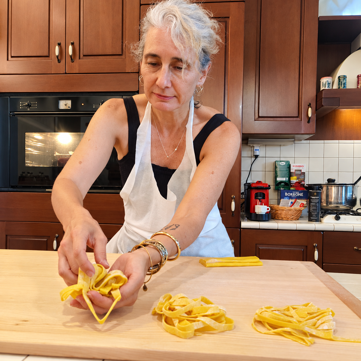 Gray-haired woman preparing pasta.png