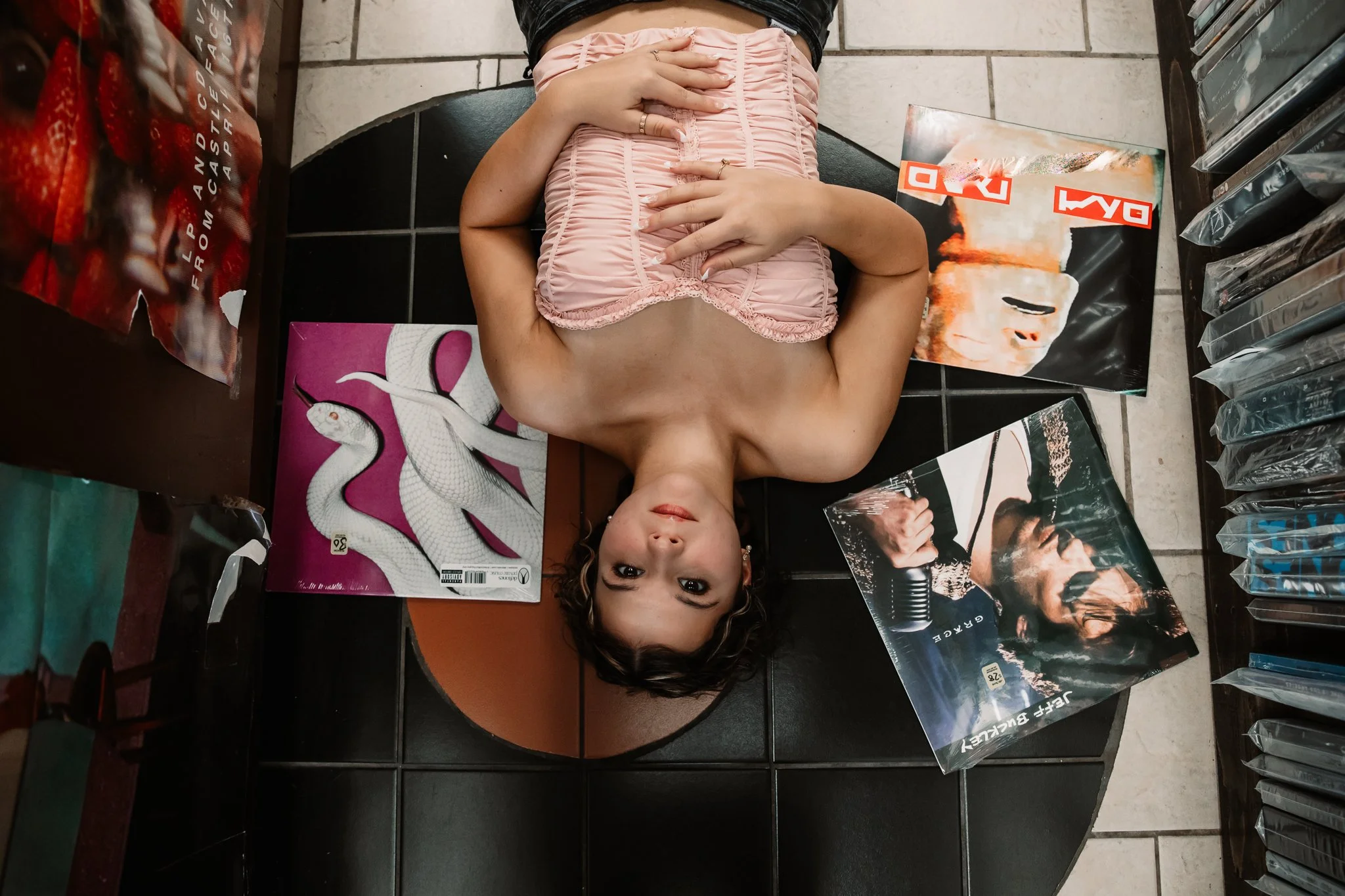 High school senior girl having creatice photos taken at Attice Record Store