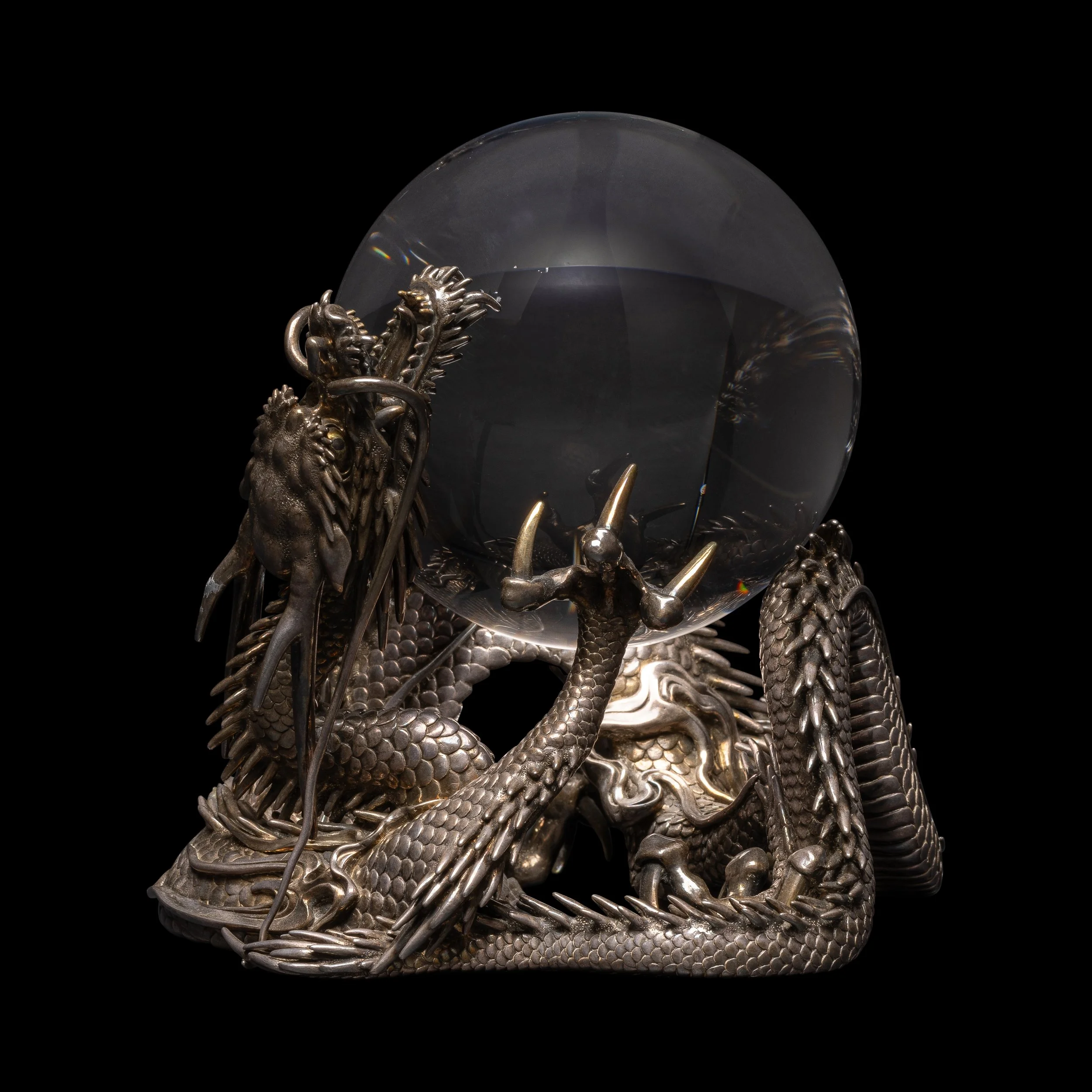 A Rock Crystal Sphere on a Silver Dragon