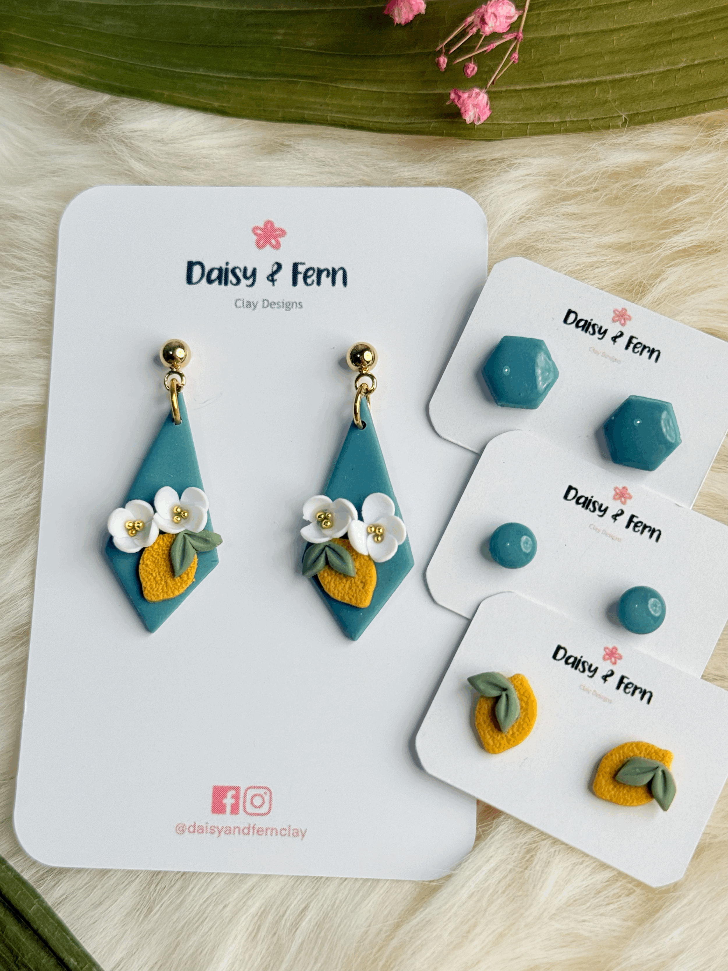 turquoise diamond shape earrings with lemon blossoms and lemons and leaves with gold caviar flower centres. hexagon, circle and lemon stud sets