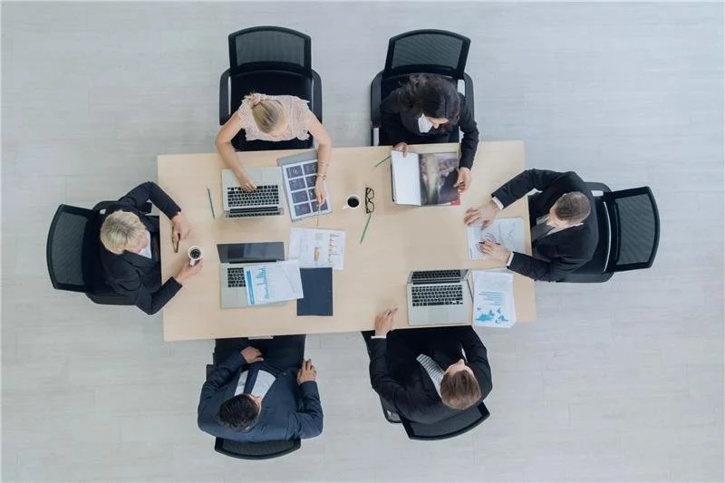 people around a table discussing insurance coverage verification