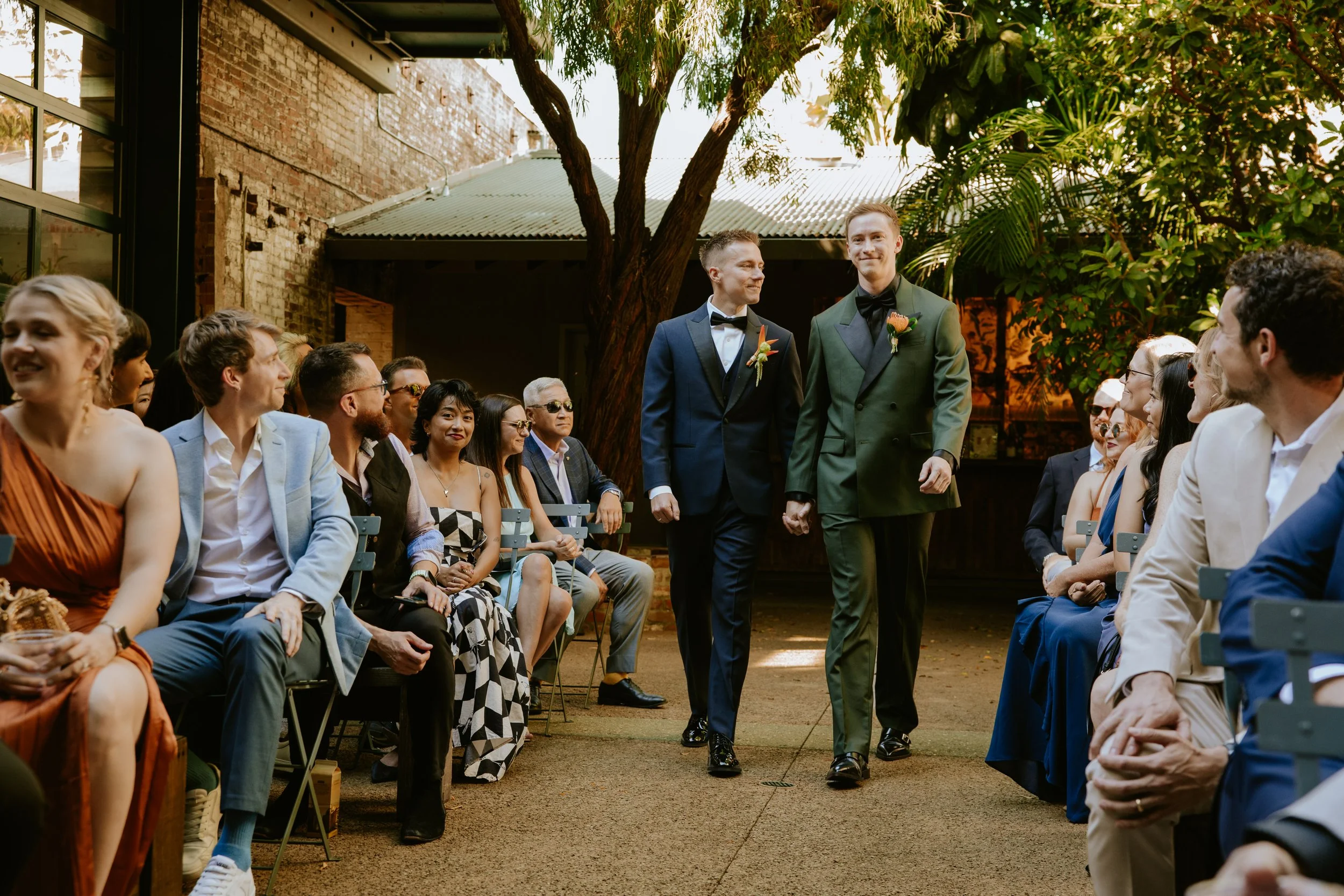 Wedding couple walking down the aisle, looking around at their guests at Millwick in DTLA