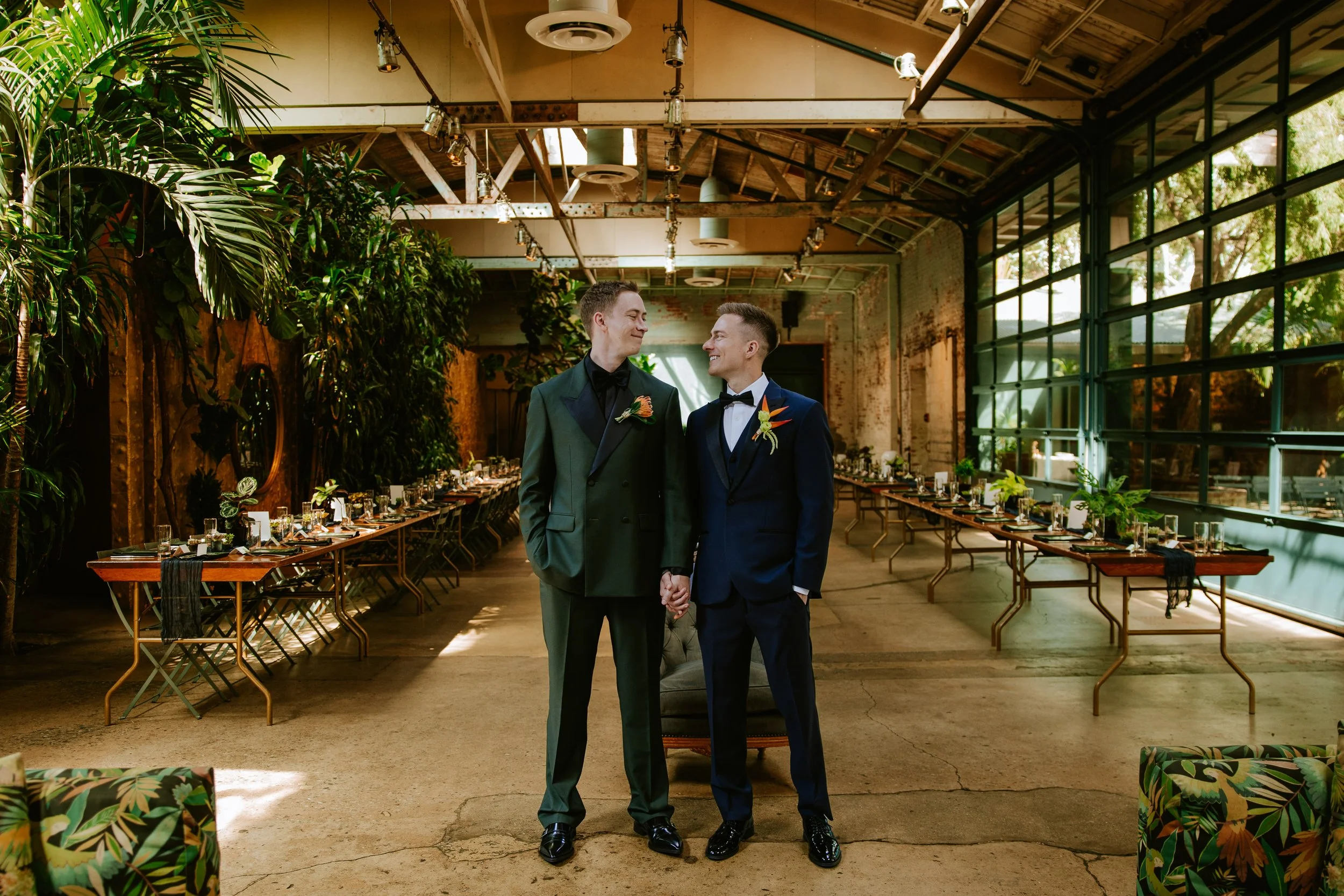 Couples stand in front of their reception hall