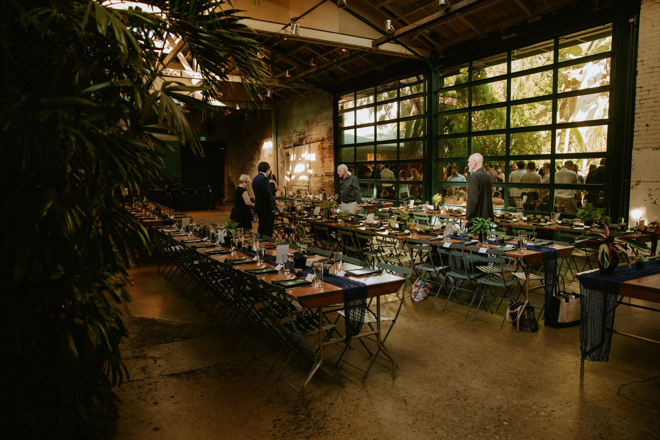 Wedding reception interior showing large glass bay doors at Millwick by Marvimon in DTLA
